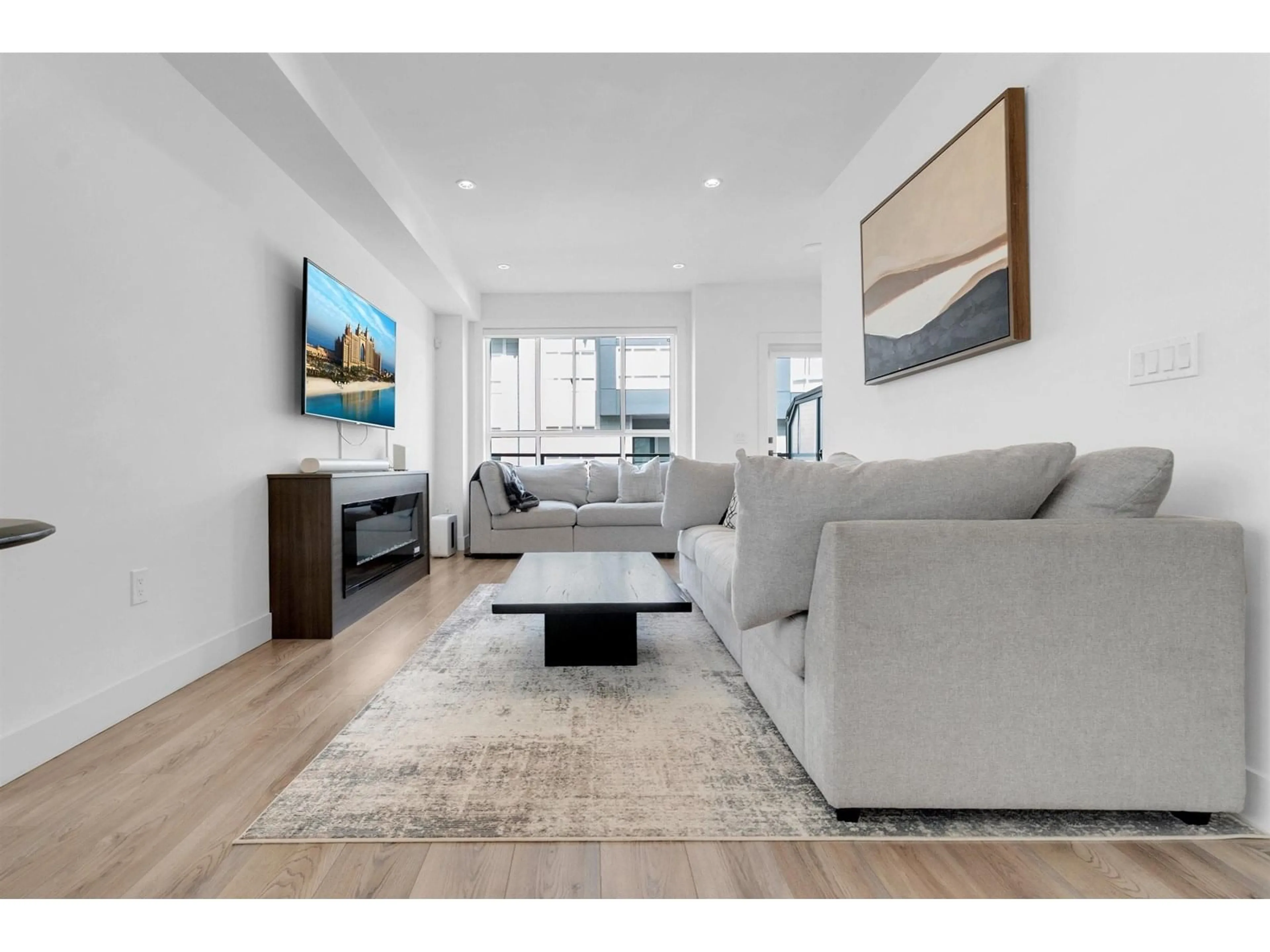 Living room with furniture, wood/laminate floor for 4 - 7050 188, Surrey British Columbia V4N3G6