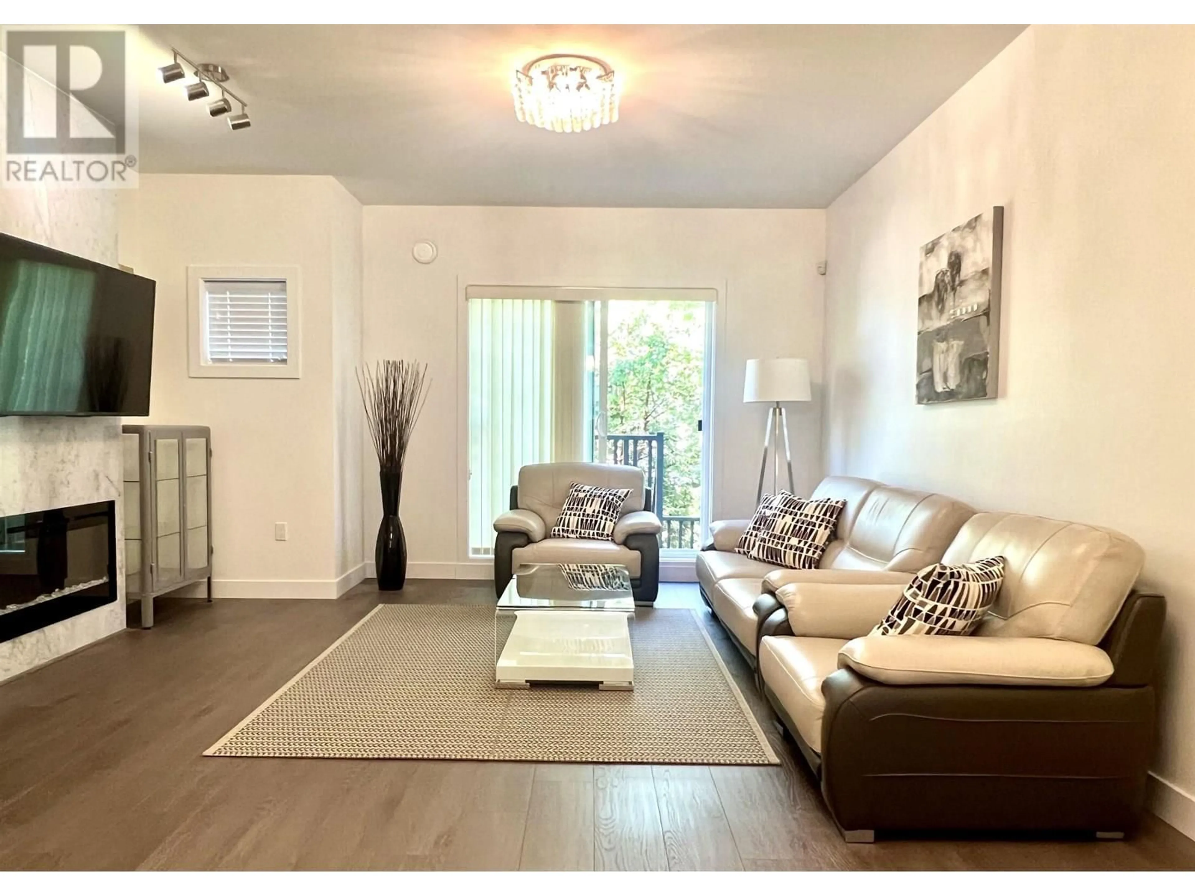 Living room with furniture, wood/laminate floor for 105 - 9080 NO. 3 ROAD, Richmond British Columbia V7A1V9