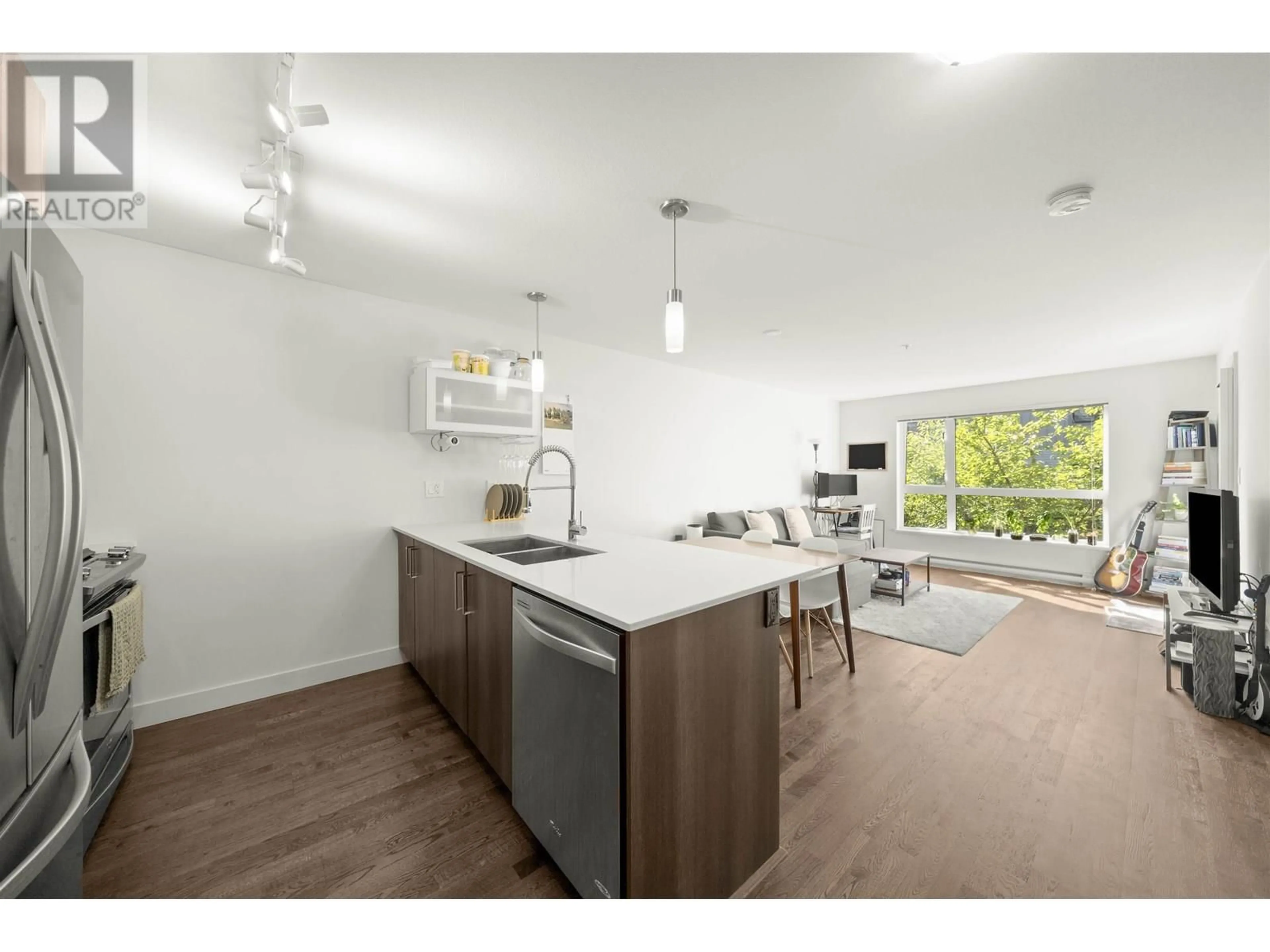 Open concept kitchen, wood/laminate floor for 218 - 7058 14TH AVENUE, Burnaby British Columbia V3N0E6