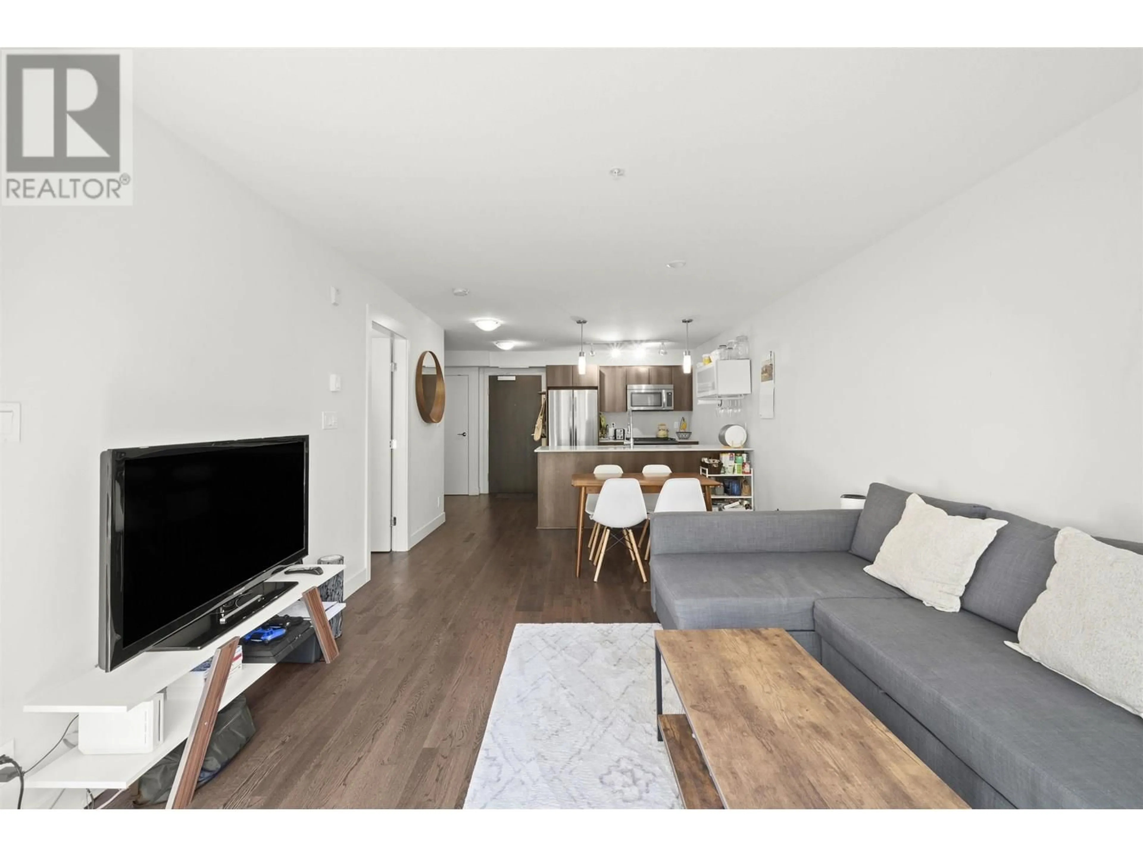 Living room with furniture, wood/laminate floor for 218 - 7058 14TH AVENUE, Burnaby British Columbia V3N0E6
