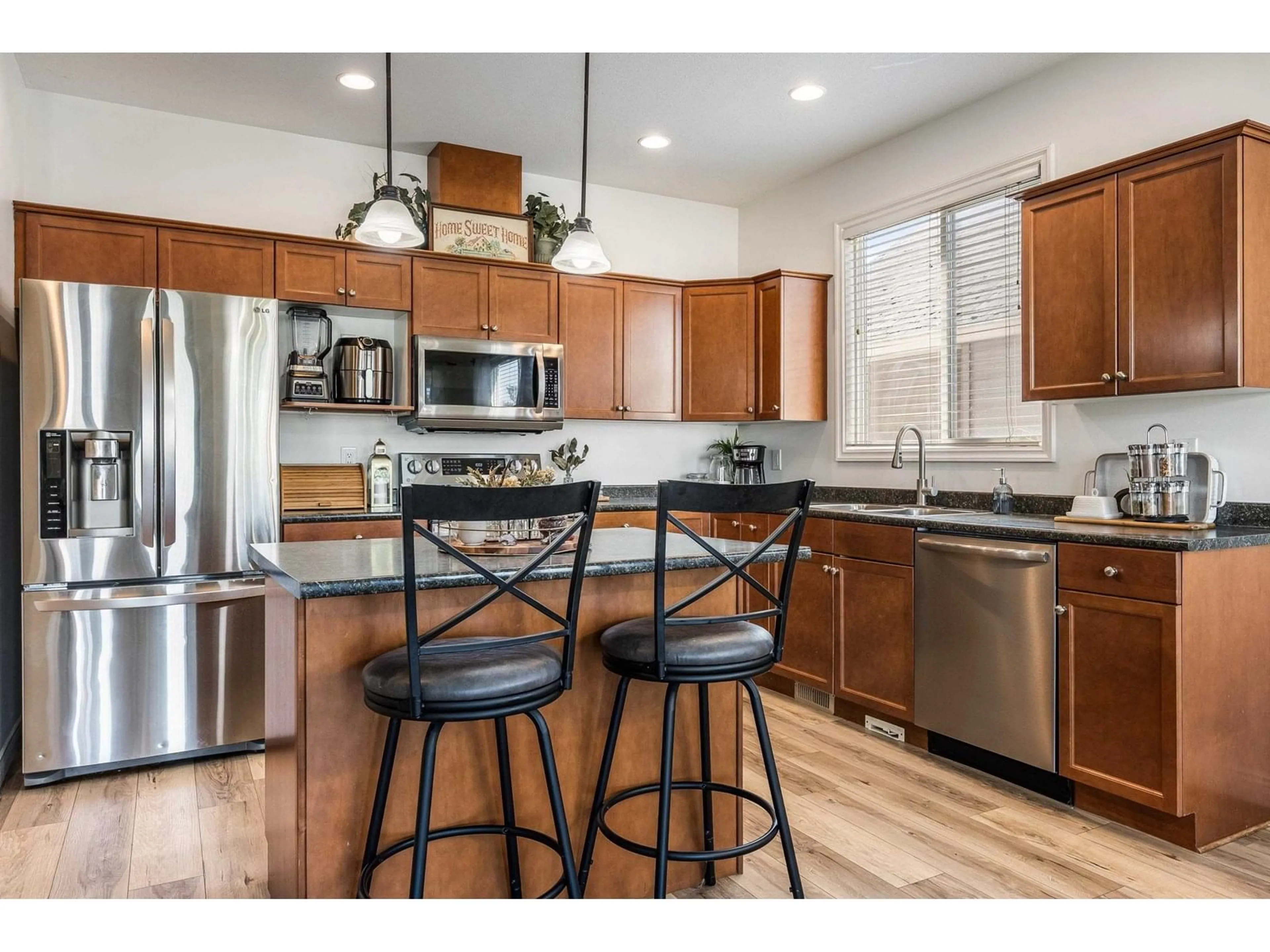 Open concept kitchen, wood/laminate floor for 9343 COOTE STREET, Chilliwack British Columbia V2P6B6