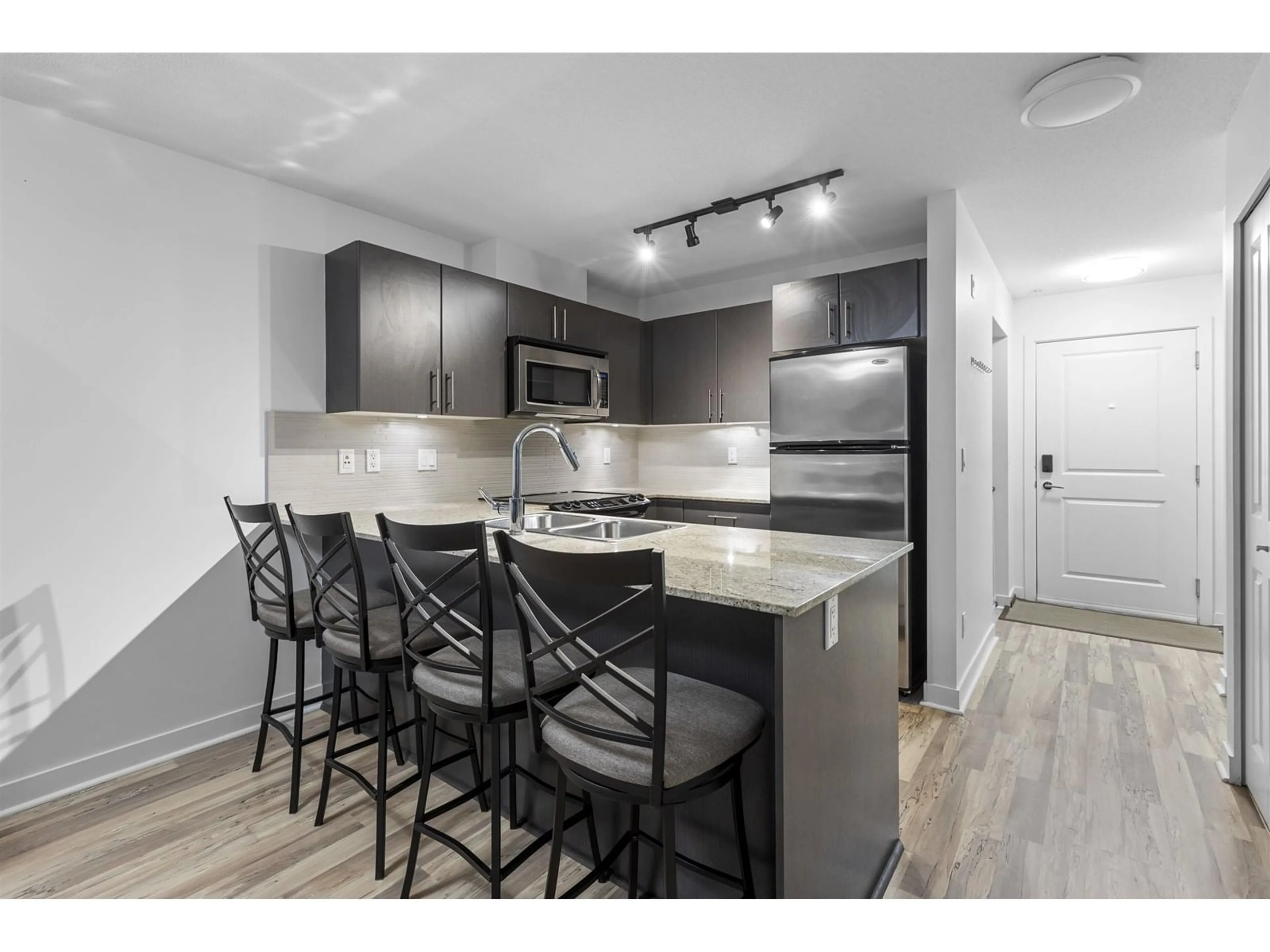 Open concept kitchen, wood/laminate floor for 119 - 8915 202, Langley British Columbia V1M0B5