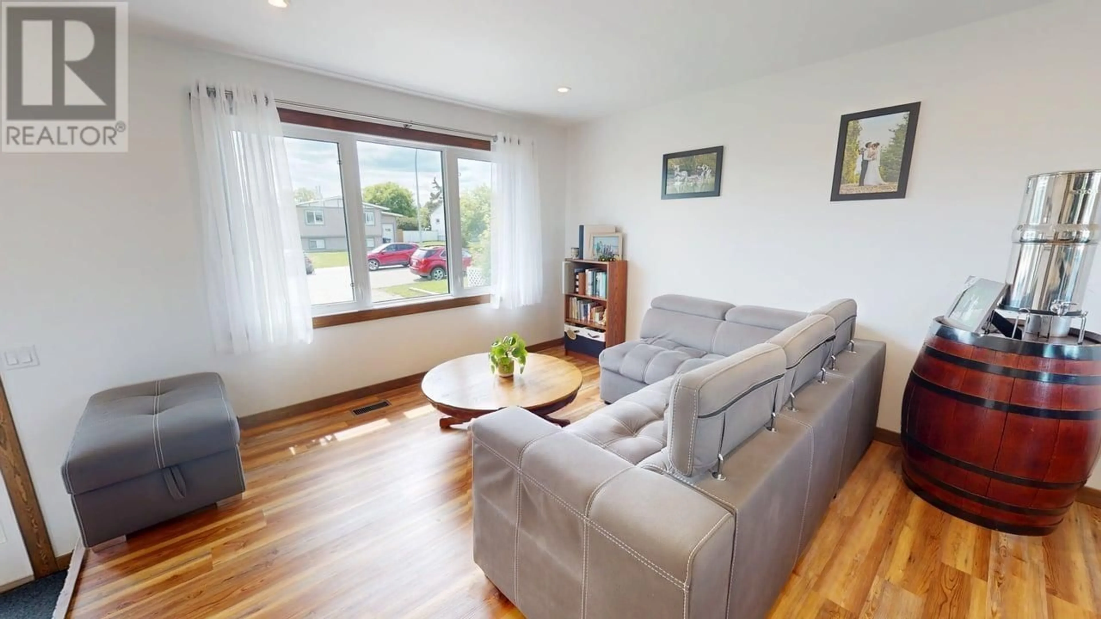 Living room with furniture, wood/laminate floor for 8132 96 AVENUE, Fort St. John British Columbia V1J1J6