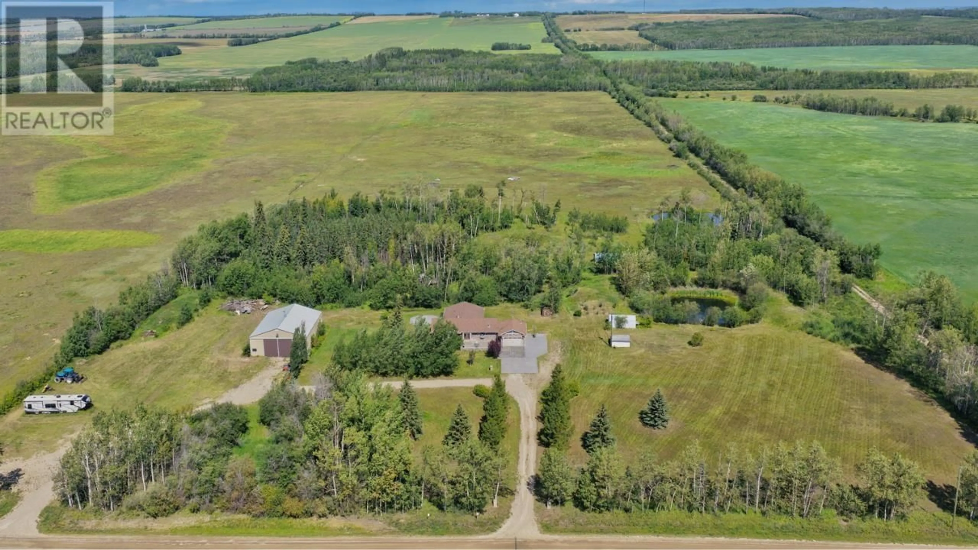 A pic from outside/outdoor area/front of a property/back of a property/a pic from drone, water/lake/river/ocean view for 5014 238 ROAD, Fort St. John British Columbia V0C1C4