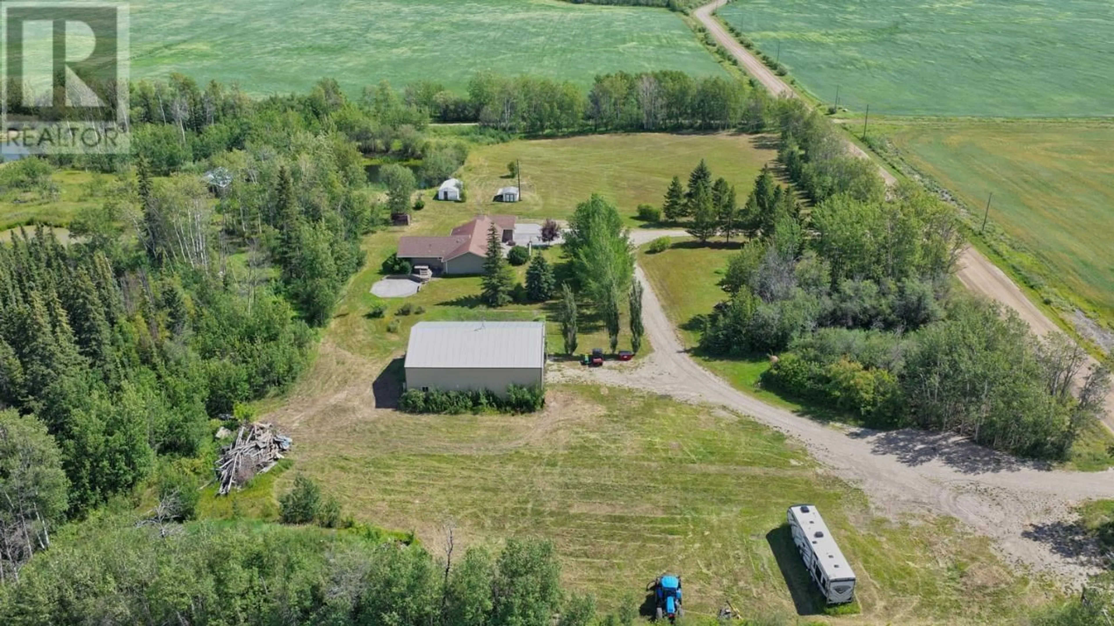 A pic from outside/outdoor area/front of a property/back of a property/a pic from drone, unknown for 5014 238 ROAD, Fort St. John British Columbia V0C1C4