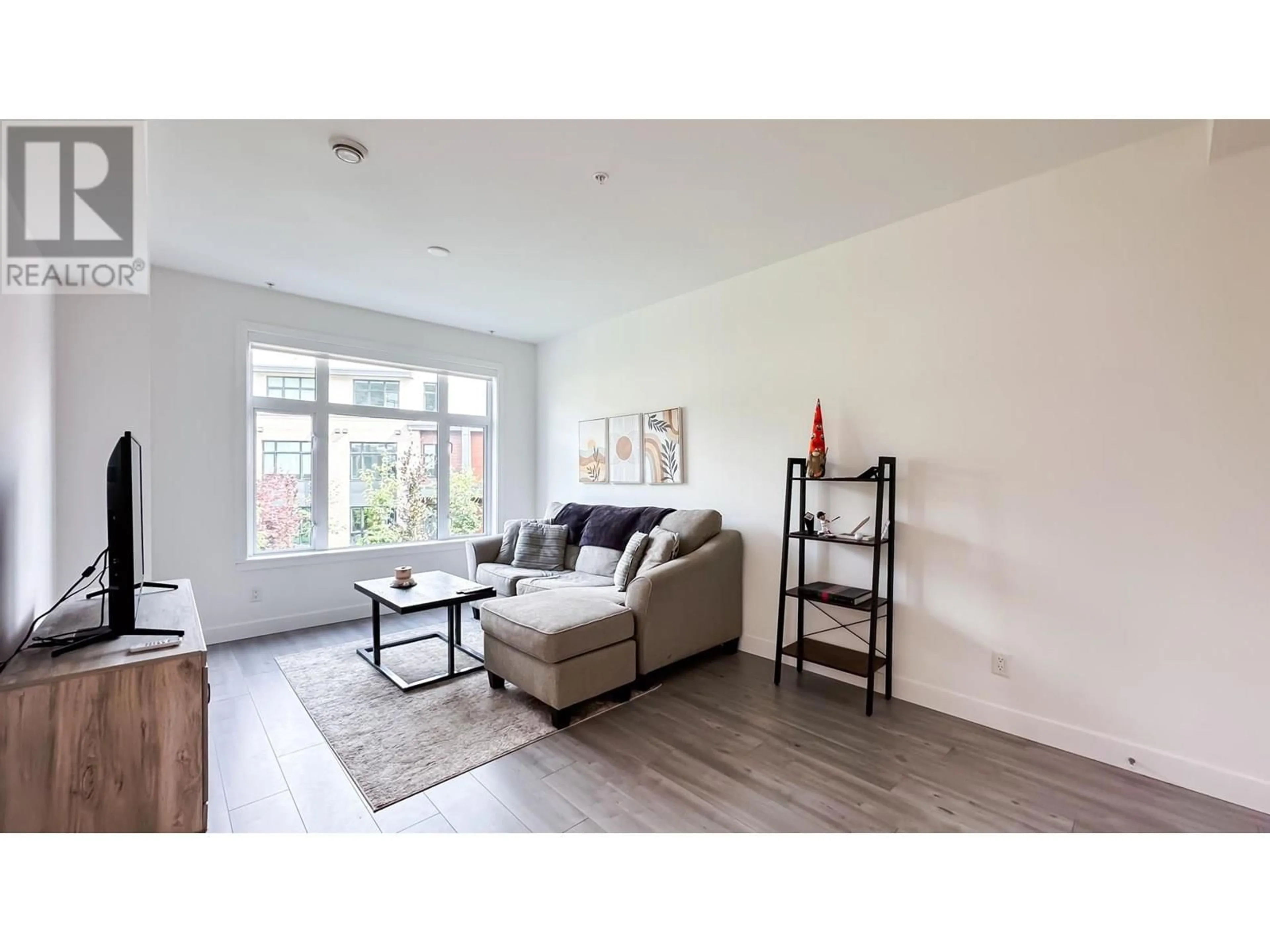 Living room with furniture, wood/laminate floor for 247 - 2035 GLENAIRE DRIVE, North Vancouver British Columbia V7P1Y2