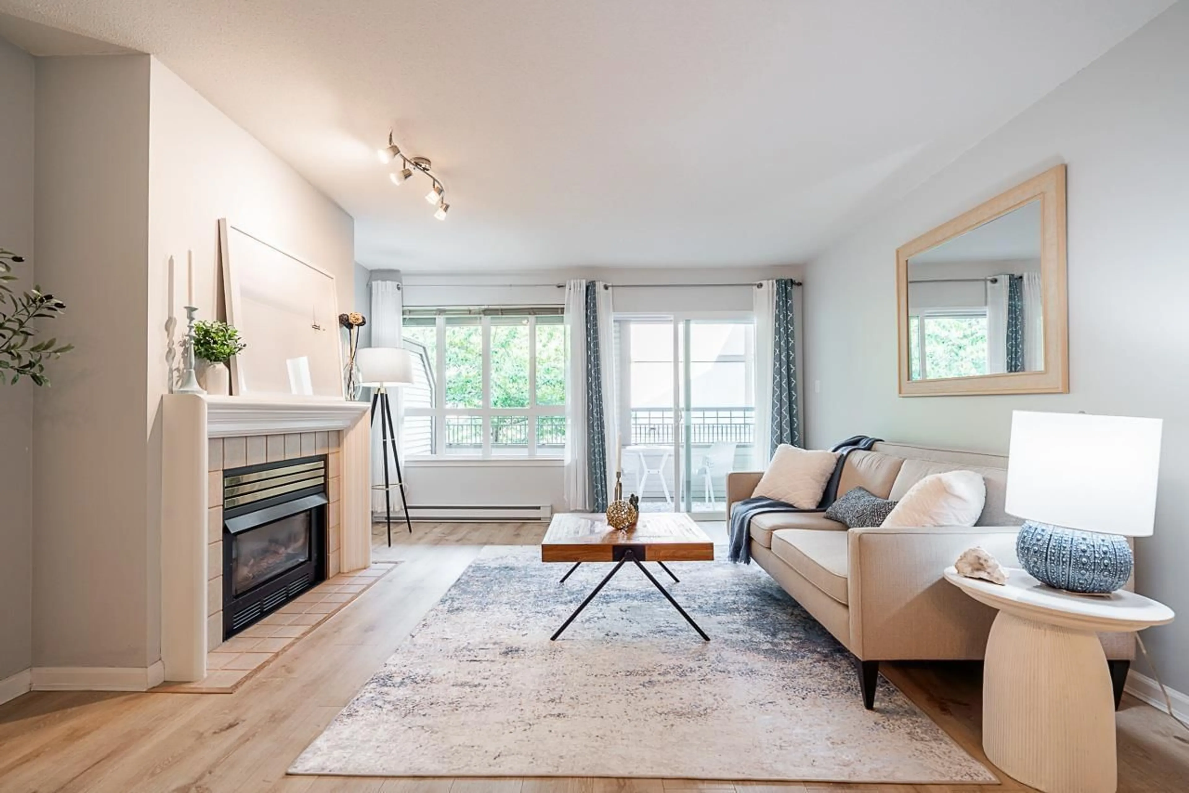 Living room with furniture, wood/laminate floor for 207 - 6363 121, Surrey British Columbia V3X3K6