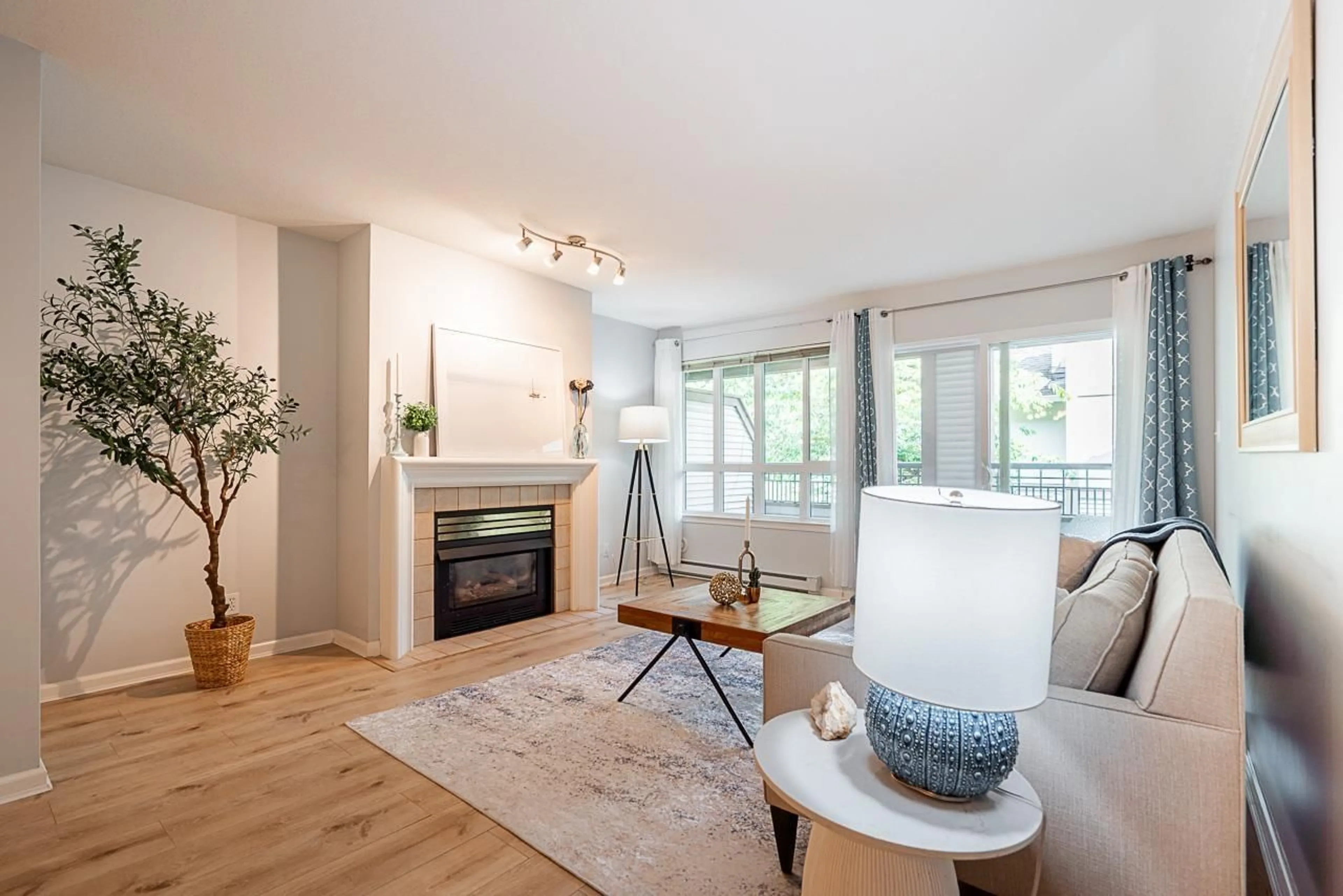 Living room with furniture, wood/laminate floor for 207 - 6363 121, Surrey British Columbia V3X3K6