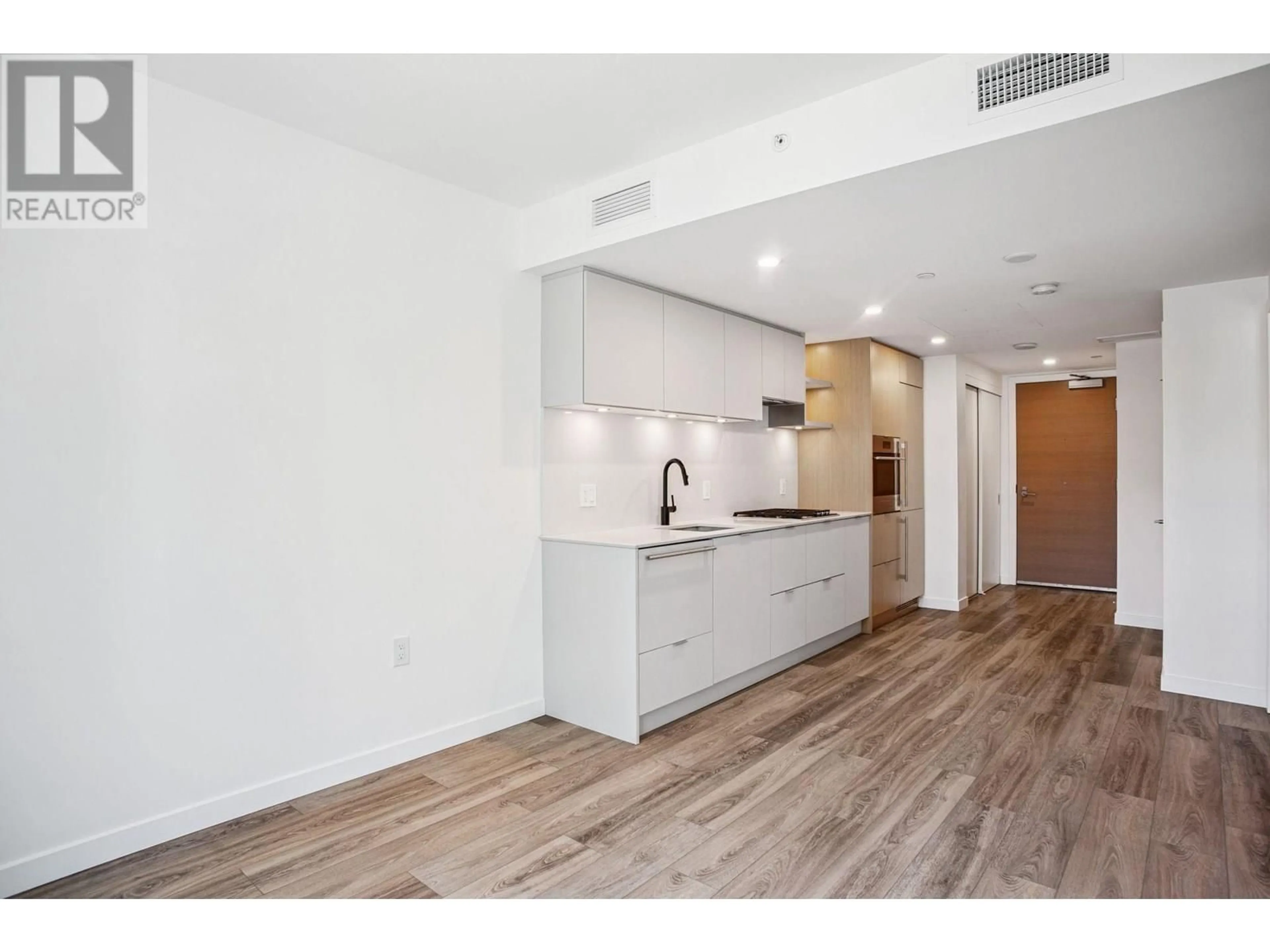 Open concept kitchen, wood/laminate floor for 401 - 210 5TH AVENUE, Vancouver British Columbia V5T0K1