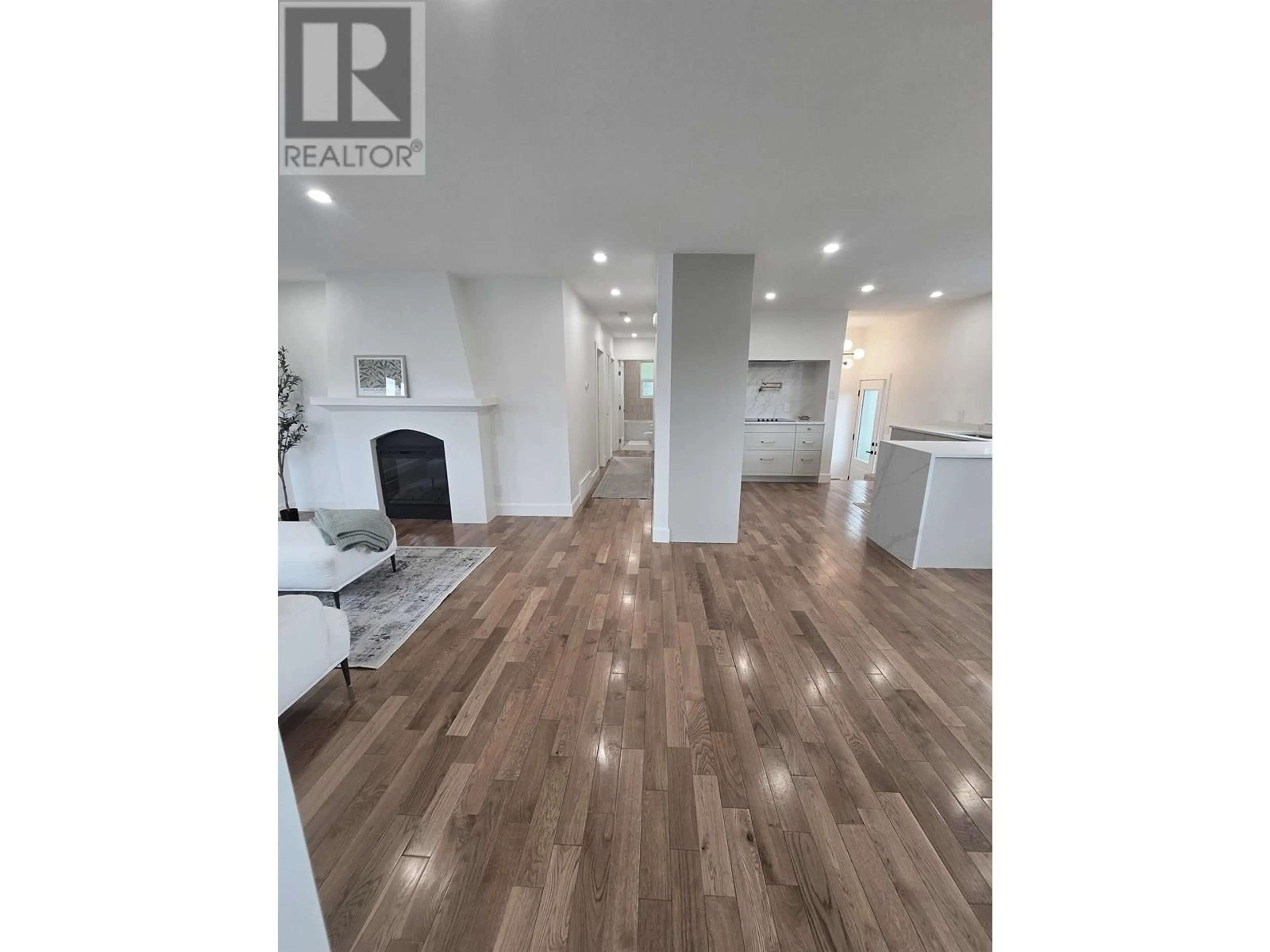 Open concept kitchen, wood/laminate floor for 10307 104 AVENUE, Fort St. John British Columbia V1J2K8