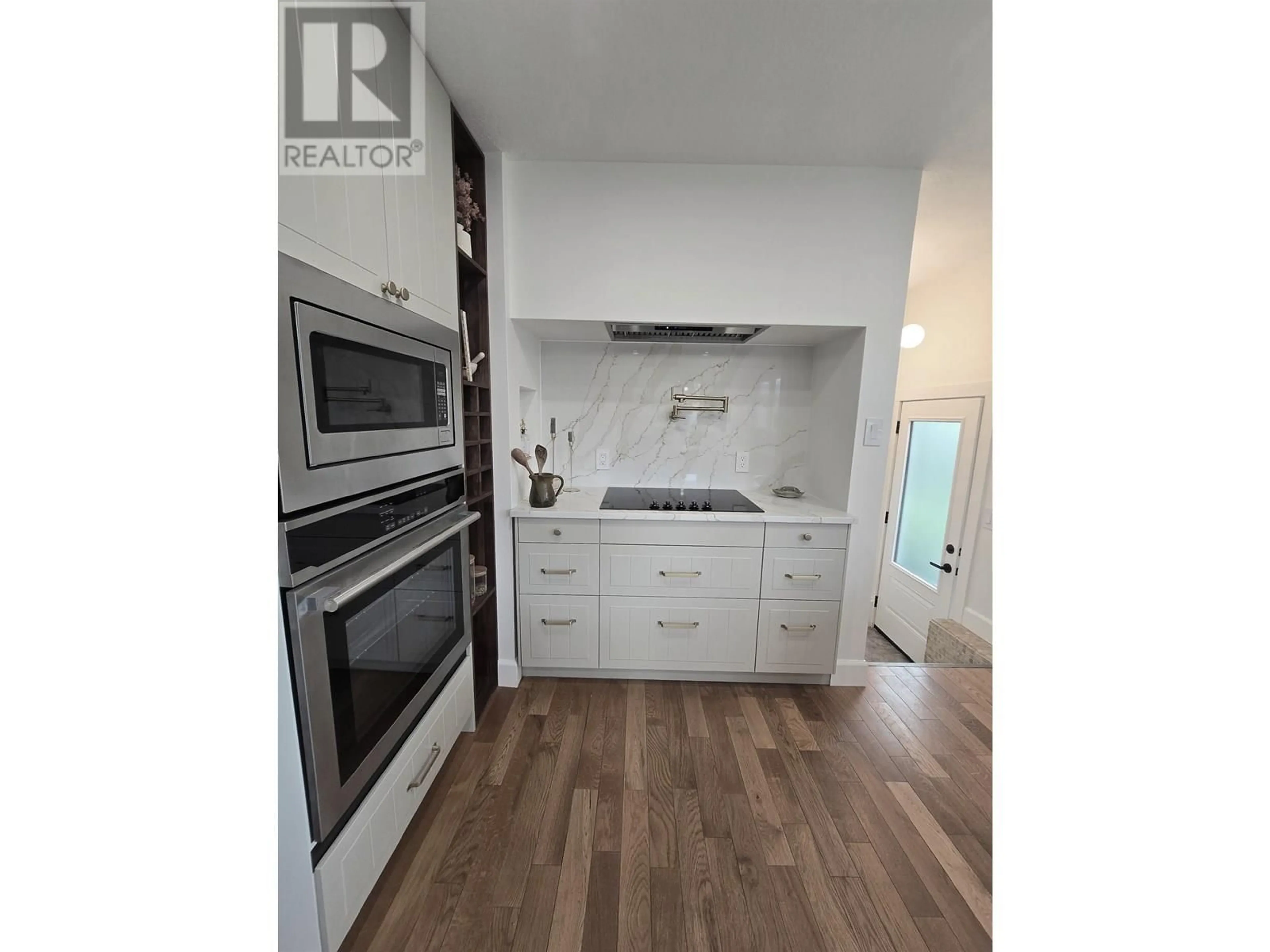 Open concept kitchen, wood/laminate floor for 10307 104 AVENUE, Fort St. John British Columbia V1J2K8