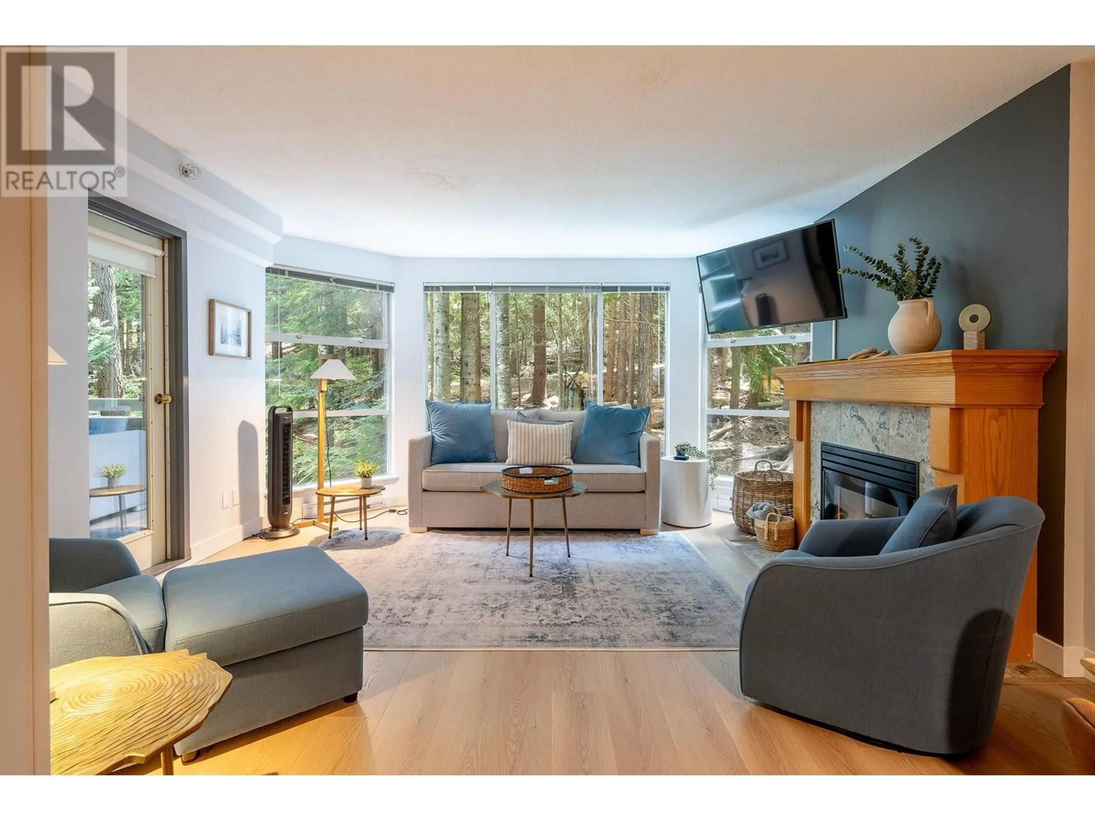 Living room with furniture, wood/laminate floor for 312 - 4910 SPEARHEAD PLACE, Whistler British Columbia V8E1G1