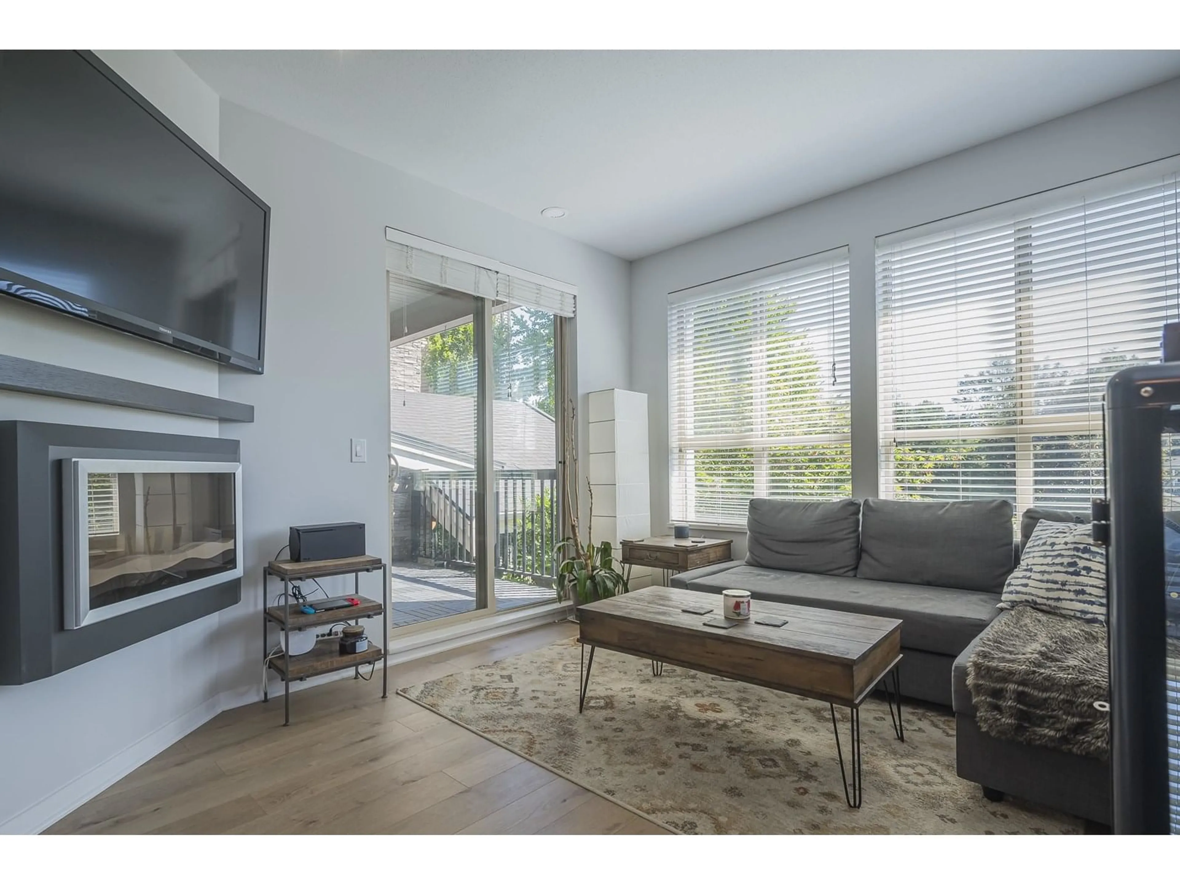 Living room with furniture, wood/laminate floor for 201 - 5655 210A, Langley British Columbia V3A0G4