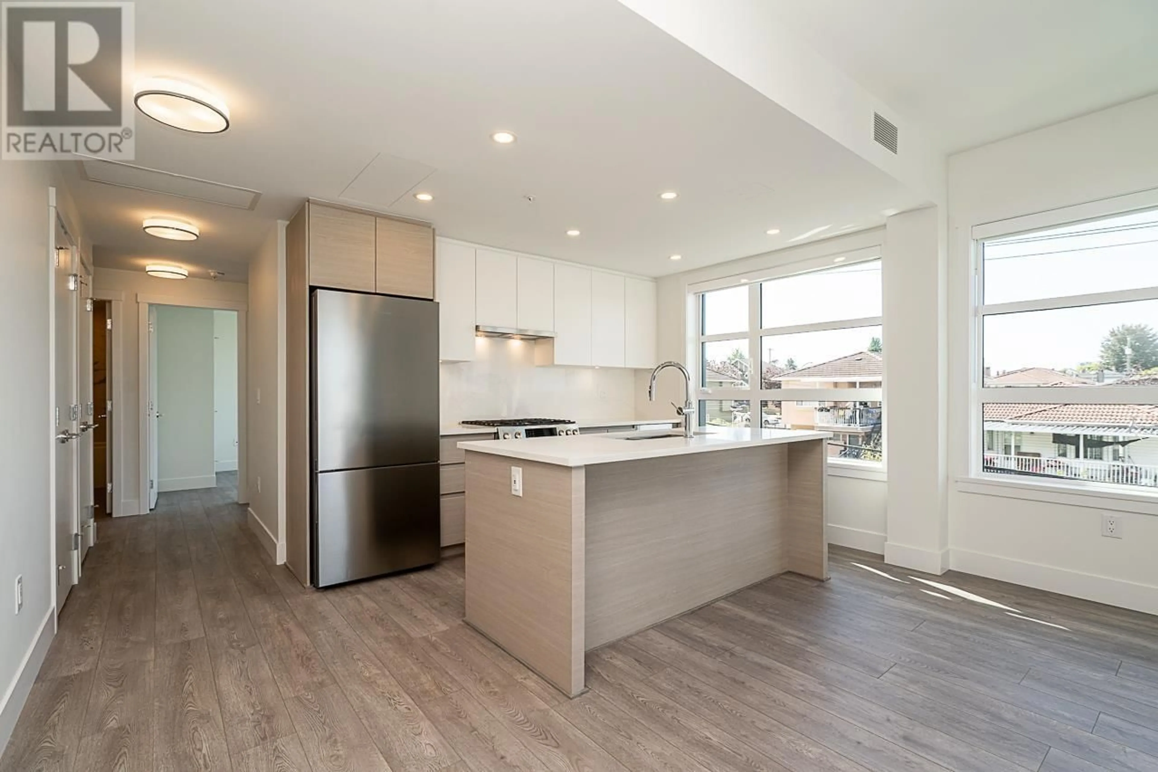 Open concept kitchen, wood/laminate floor for 313 - 4788 HASTINGS STREET, Burnaby British Columbia V5C0P4