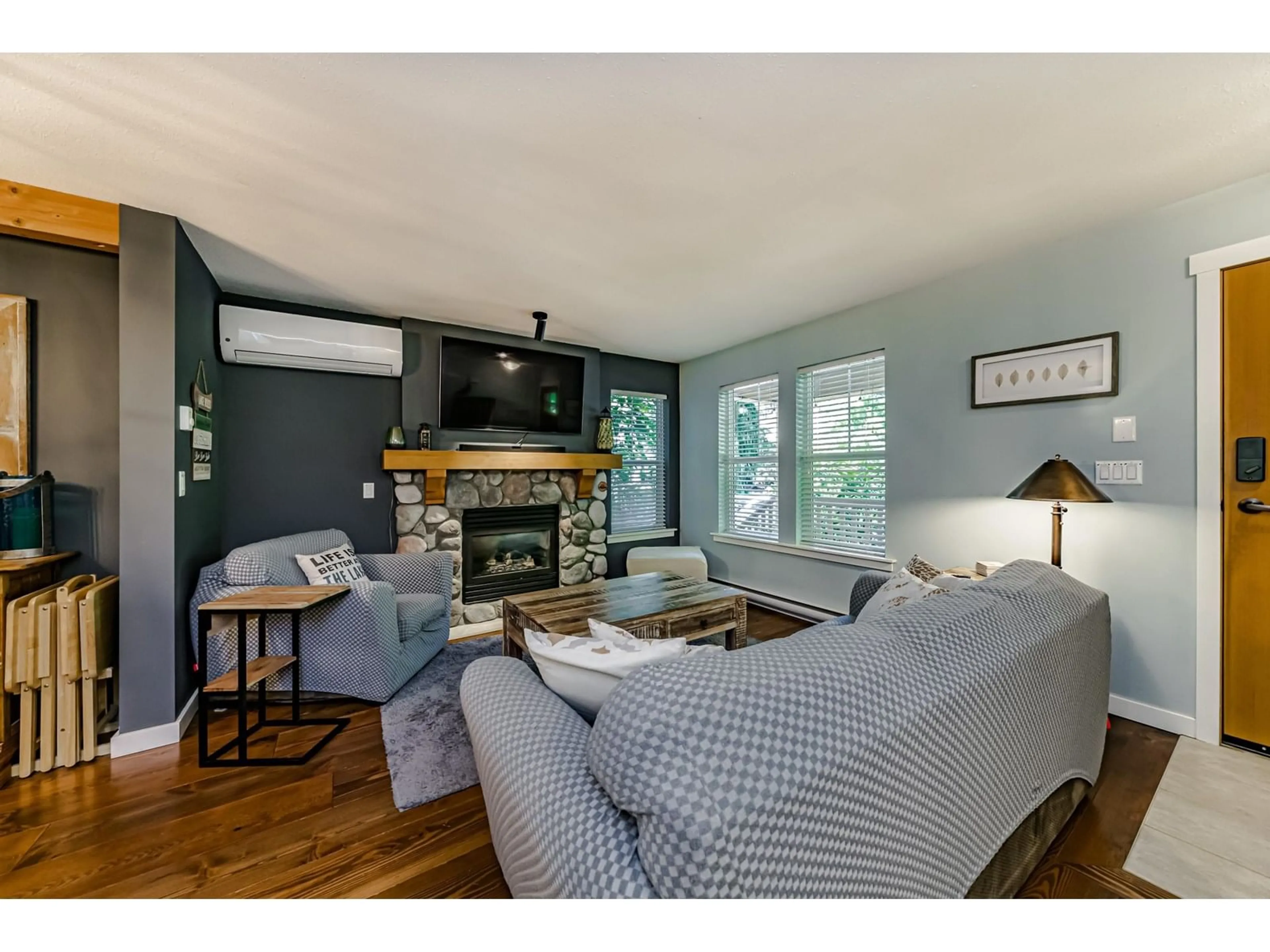 Living room with furniture, wood/laminate floor for 43532 RED HAWK PASS, Lindell Beach British Columbia V2R0E1