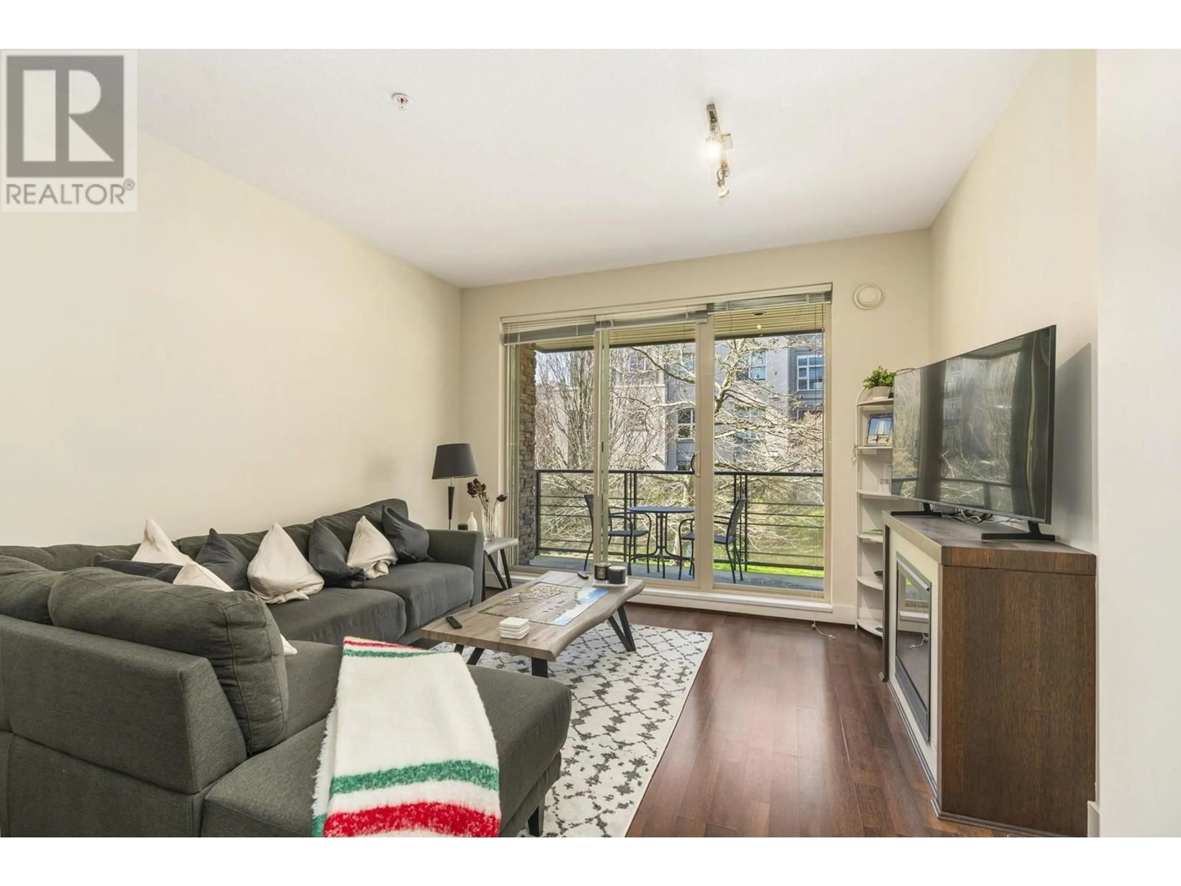 Living room with furniture, wood/laminate floor for 212 - 3478 WESBROOK MALL, Vancouver British Columbia V6S0B6