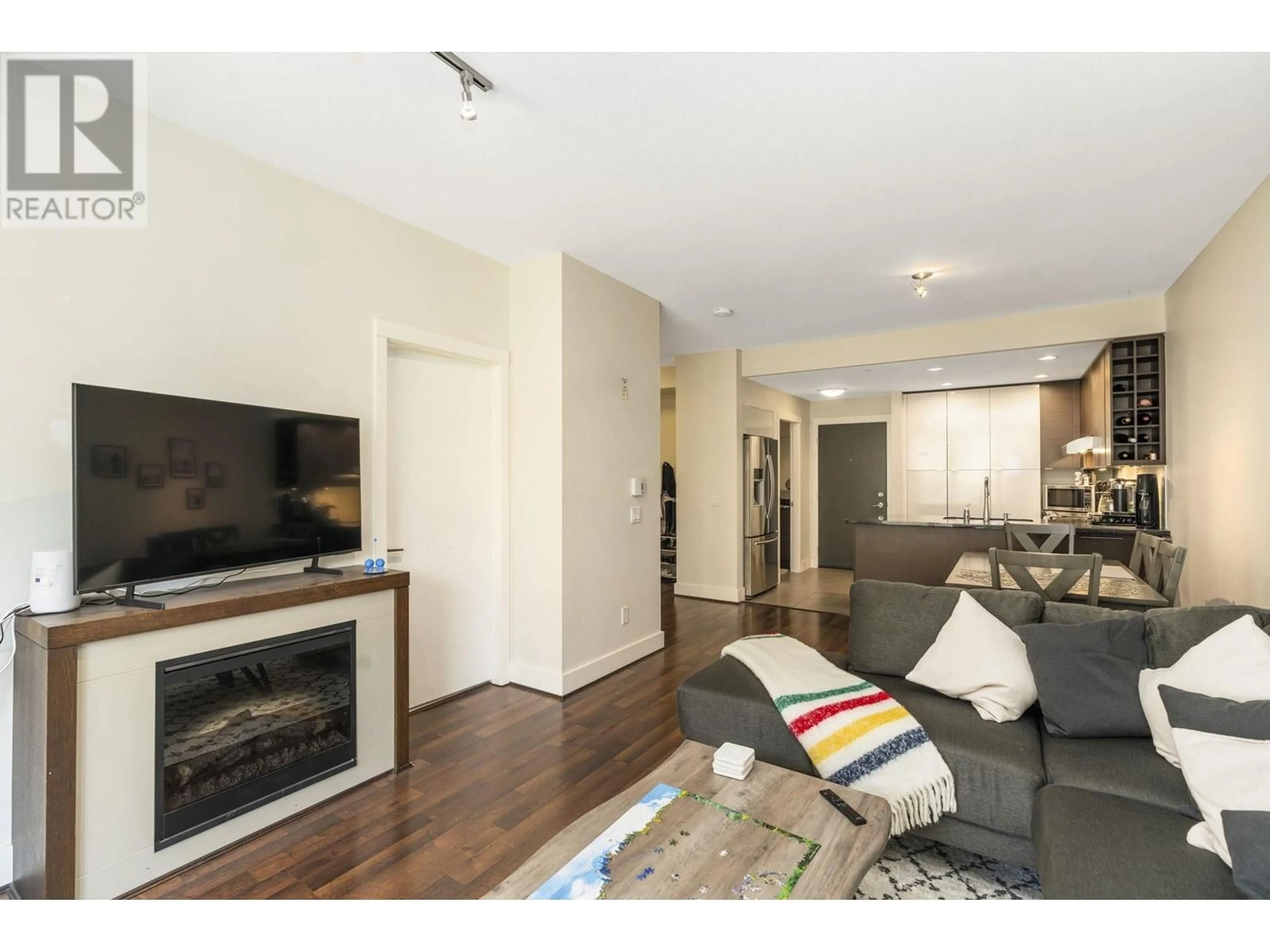 Living room with furniture, wood/laminate floor for 212 - 3478 WESBROOK MALL, Vancouver British Columbia V6S0B6