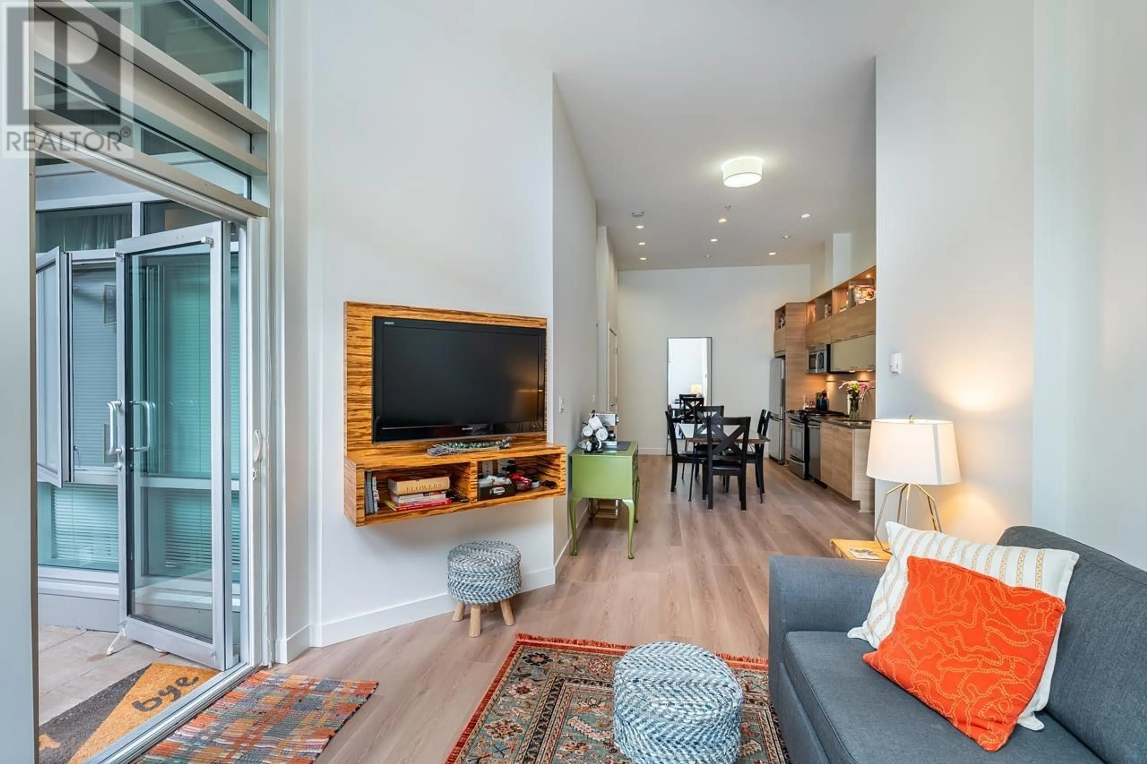 Living room with furniture, wood/laminate floor for 6 - 9150 UNIVERSITY HIGH STREET, Burnaby British Columbia V5A0C5
