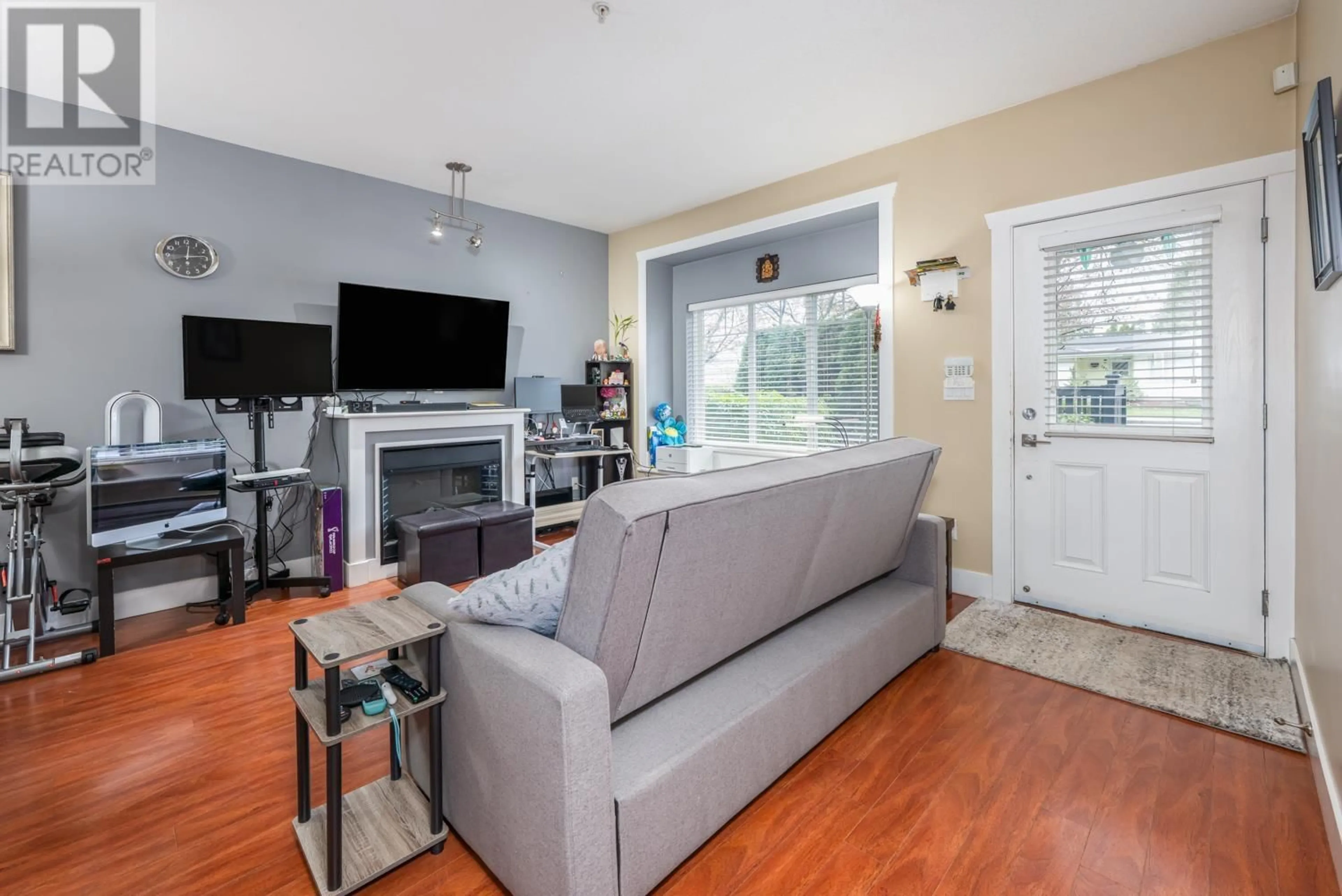 Living room with furniture, wood/laminate floor for 104 - 5211 IRMIN STREET, Burnaby British Columbia V5J0C9
