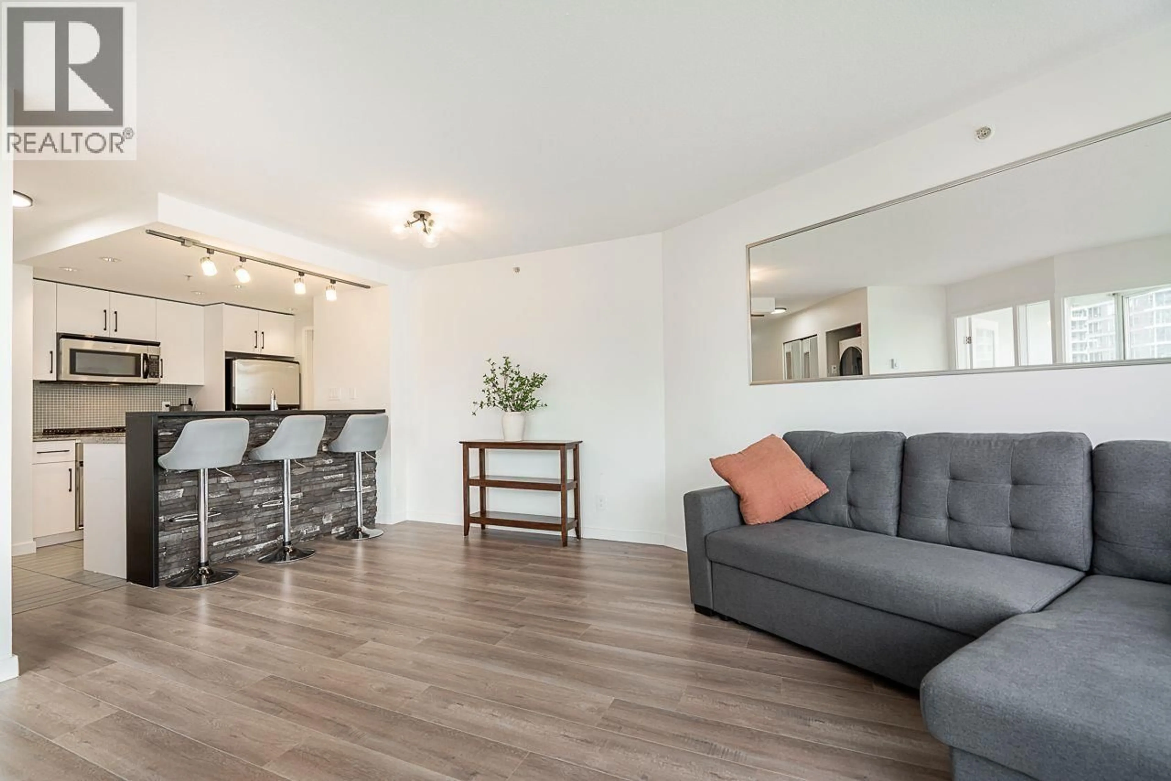 Living room with furniture, wood/laminate floor for 603 - 980 COOPERAGE WAY, Vancouver British Columbia V6B0C3