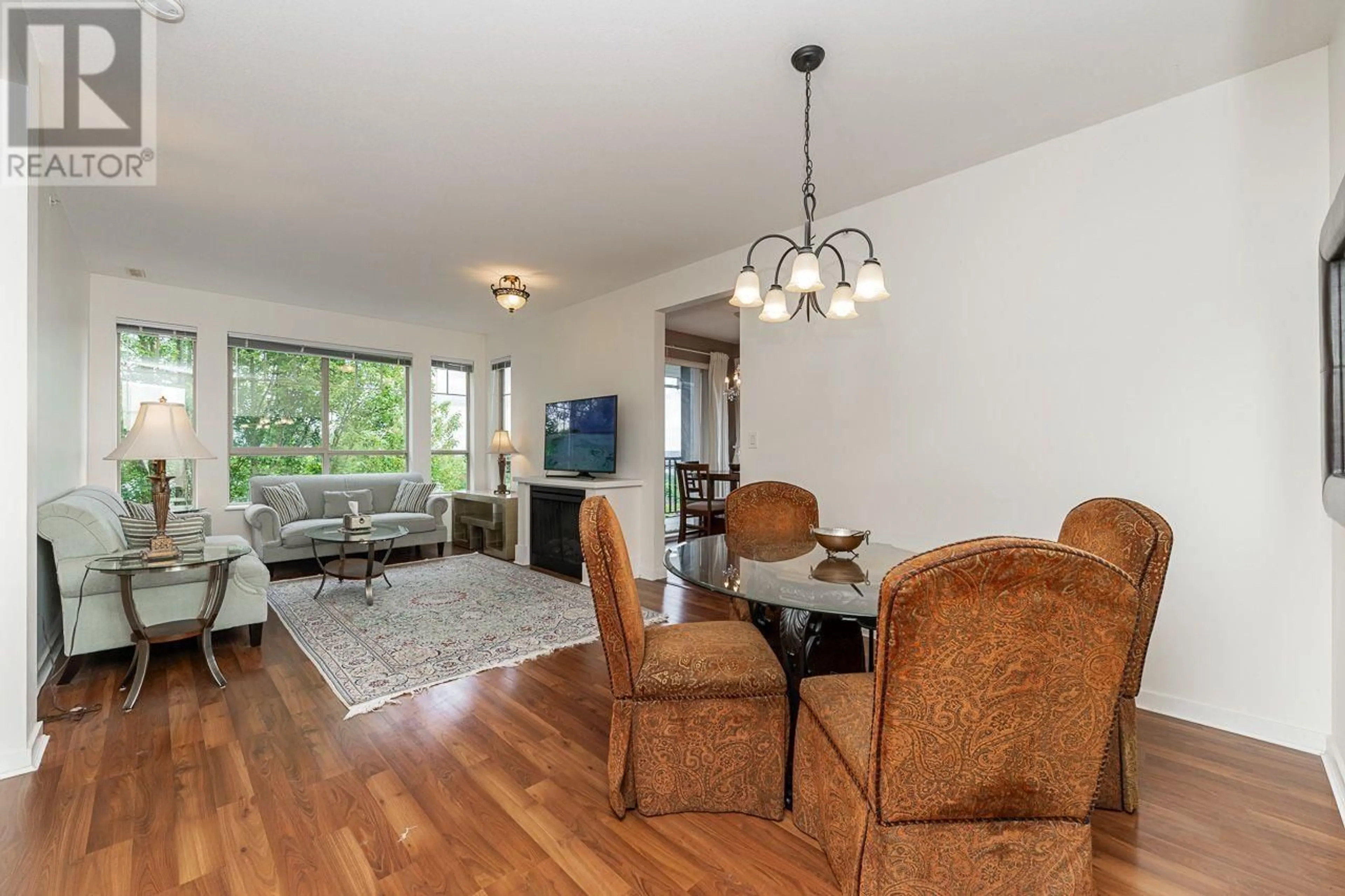 Living room with furniture, wood/laminate floor for 414 - 2969 WHISPER WAY, Coquitlam British Columbia V3E3S8