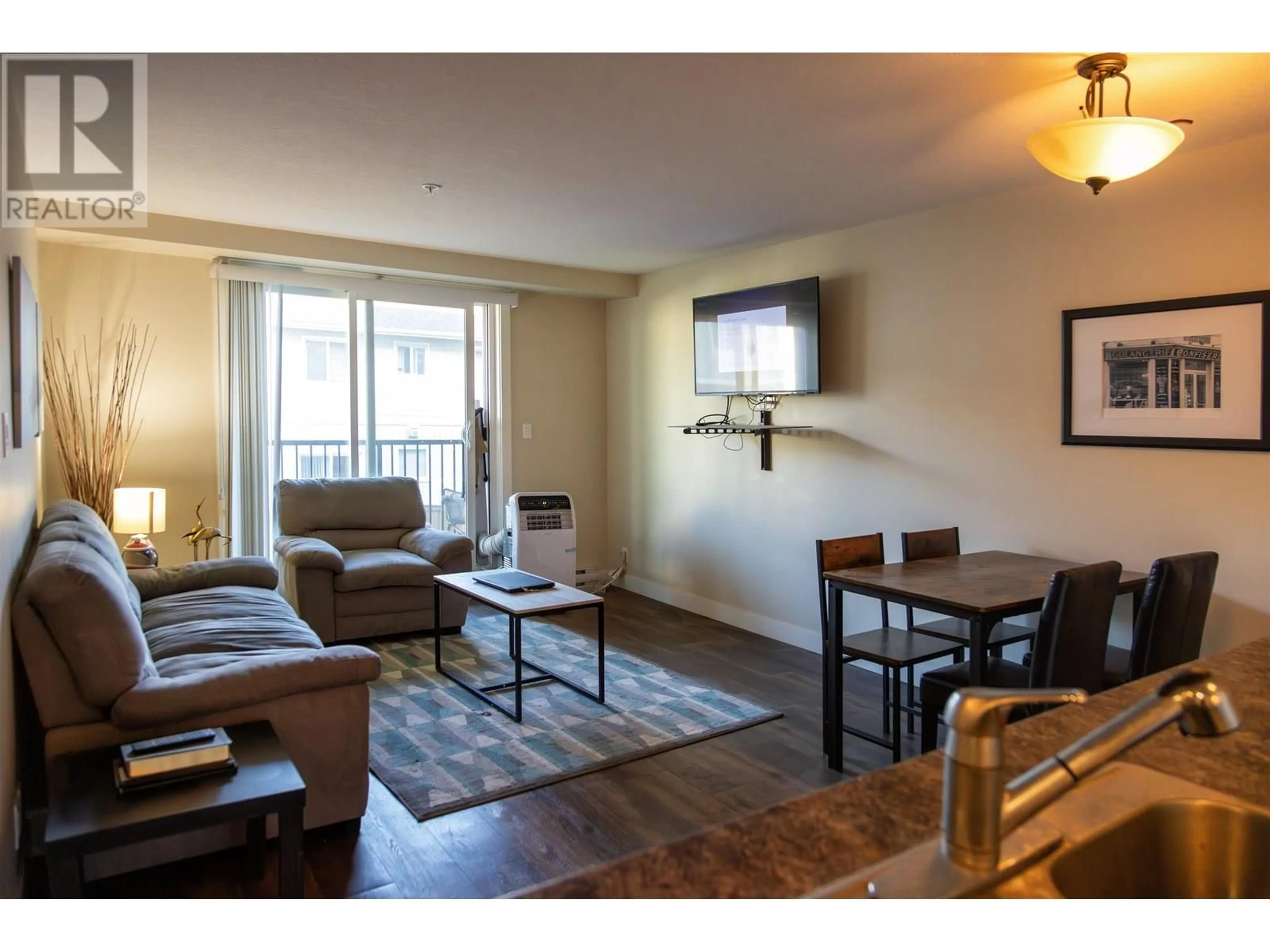 Living room with furniture, wood/laminate floor for 207 - 11004 102 AVENUE, Fort St. John British Columbia V1J0L9