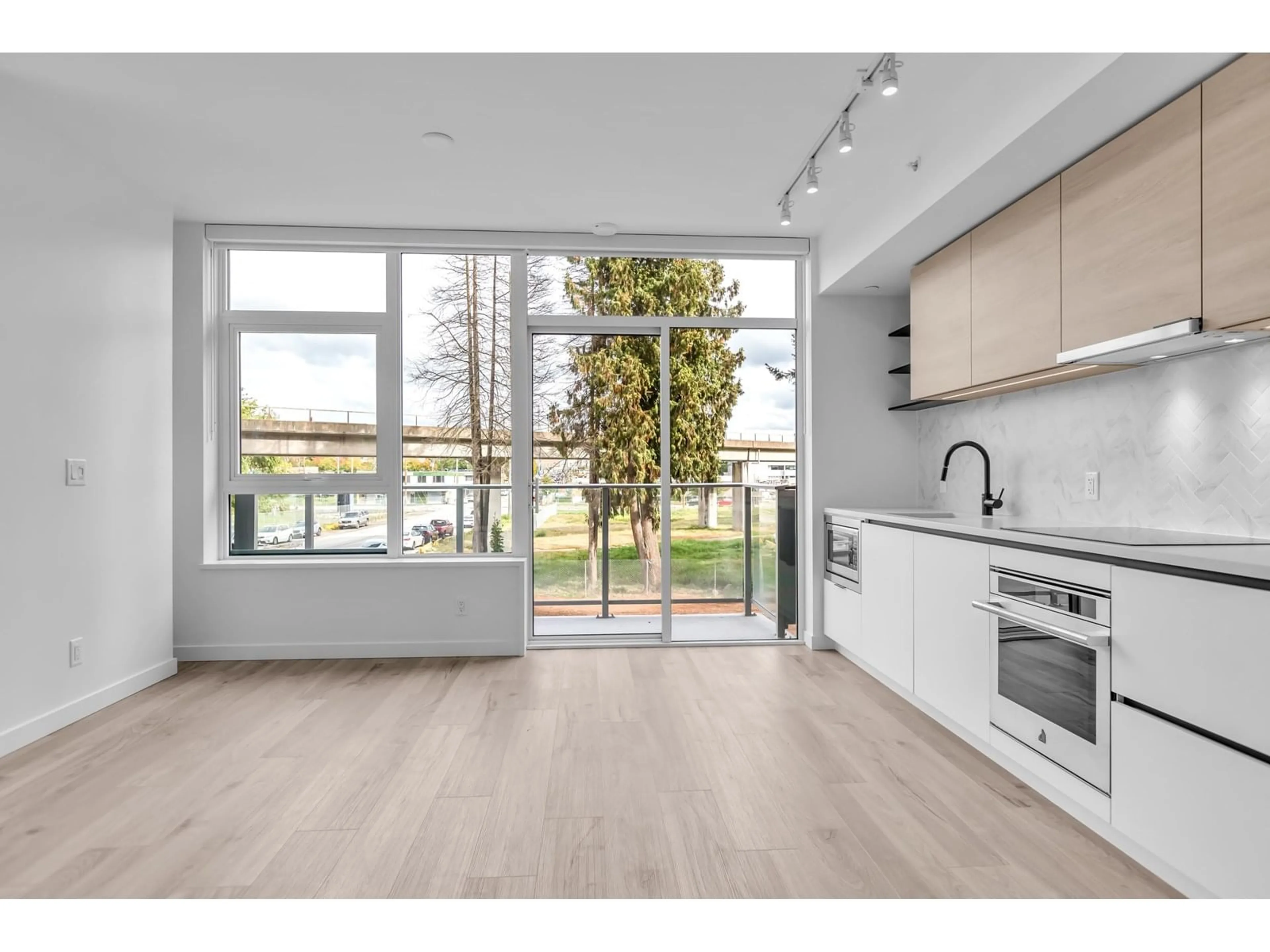 Open concept kitchen, wood/laminate floor for 201 - 13428 105, Surrey British Columbia V3T0S6