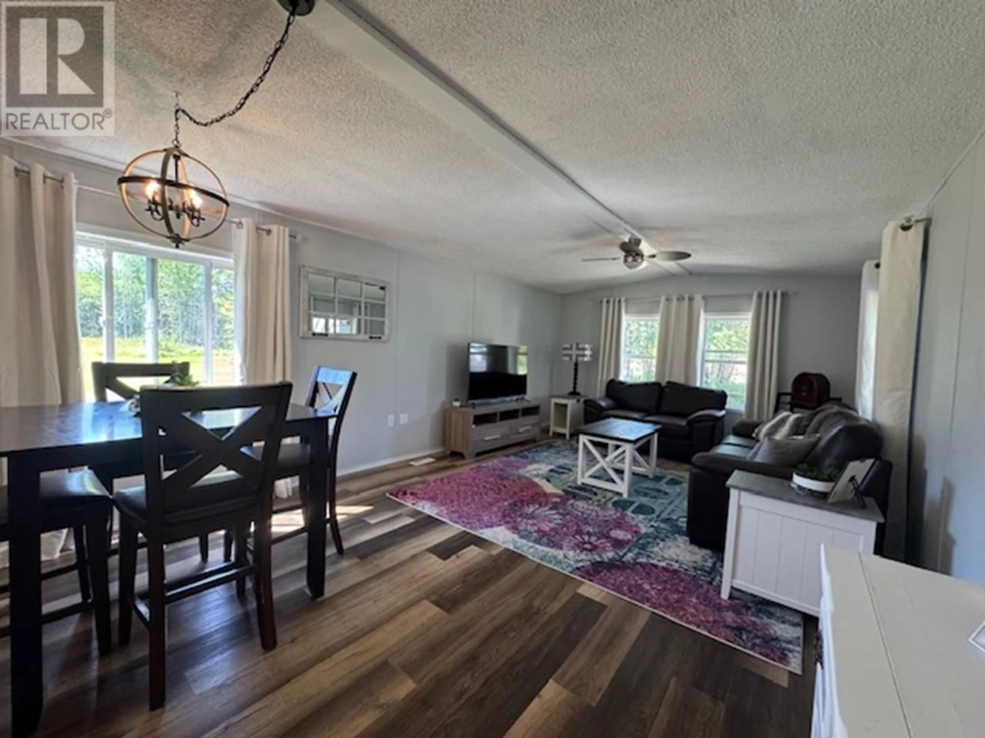 Living room with furniture, wood/laminate floor for 6770 PARSNIP ROAD, Prince George British Columbia V2N6E8