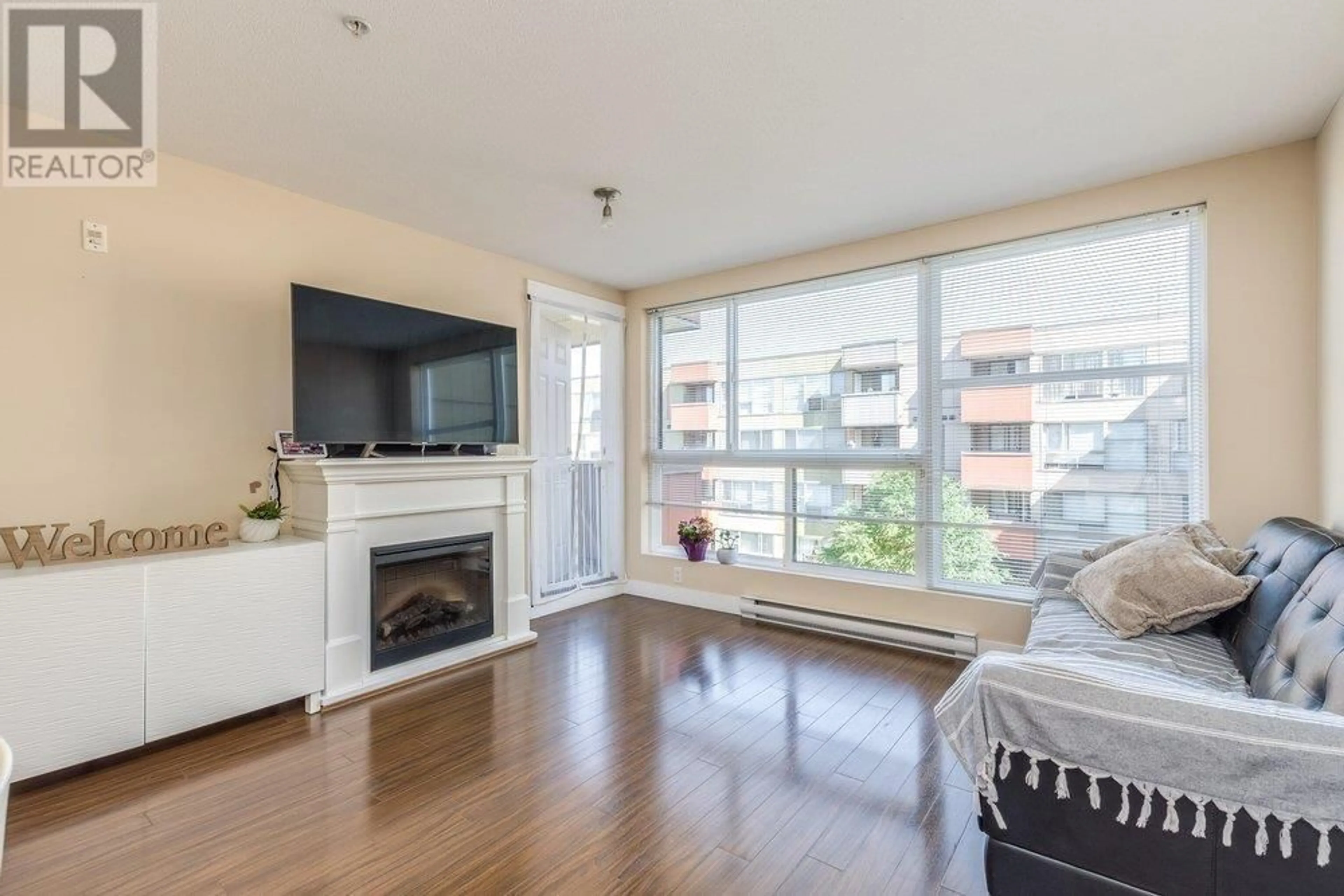 Living room with furniture, wood/laminate floor for 313 - 12075 228 STREET, Maple Ridge British Columbia V2X6M2