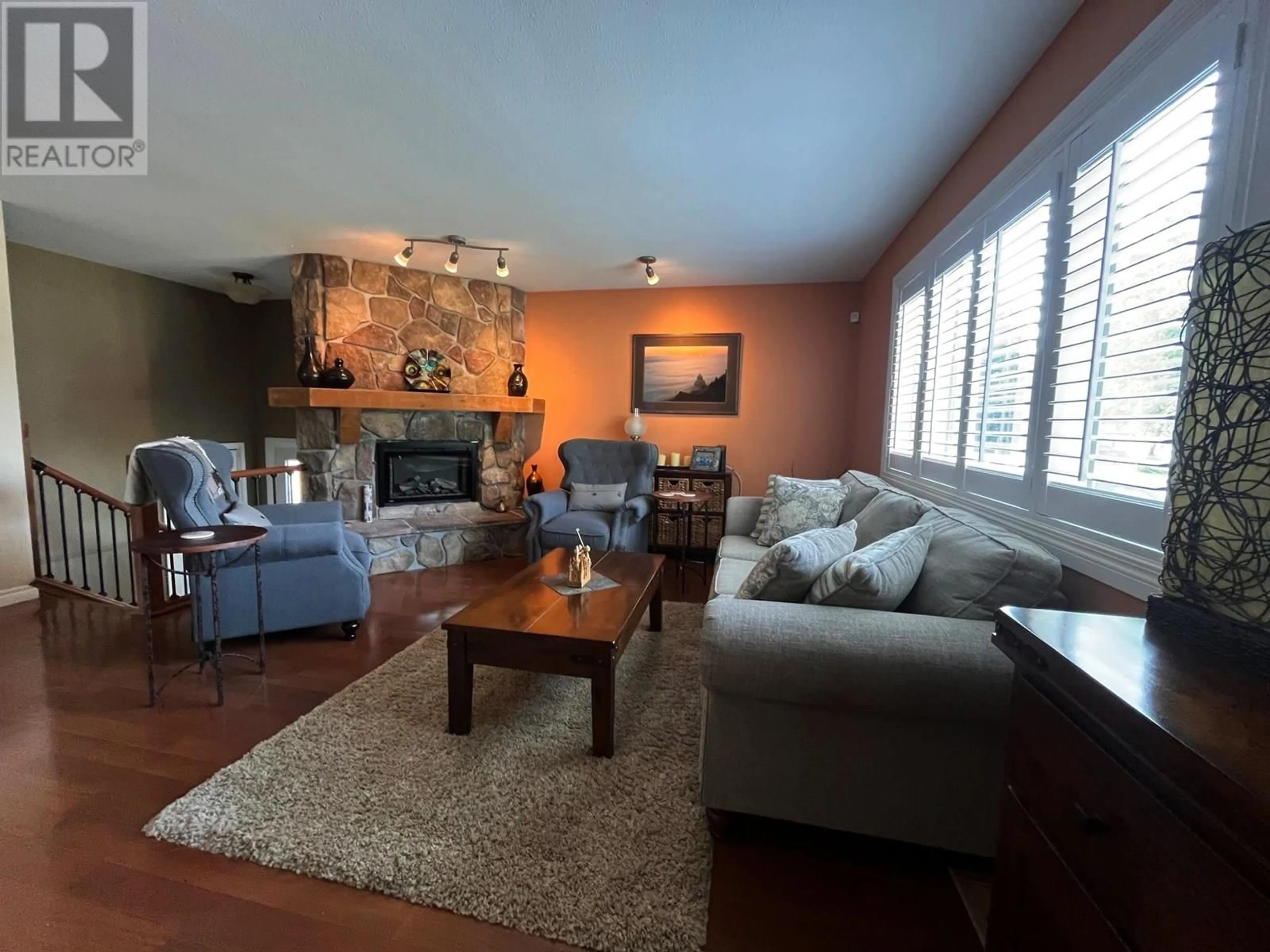 Living room with furniture, wood/laminate floor for 7717 KINGSLEY CRESCENT, Prince George British Columbia V2N3M9
