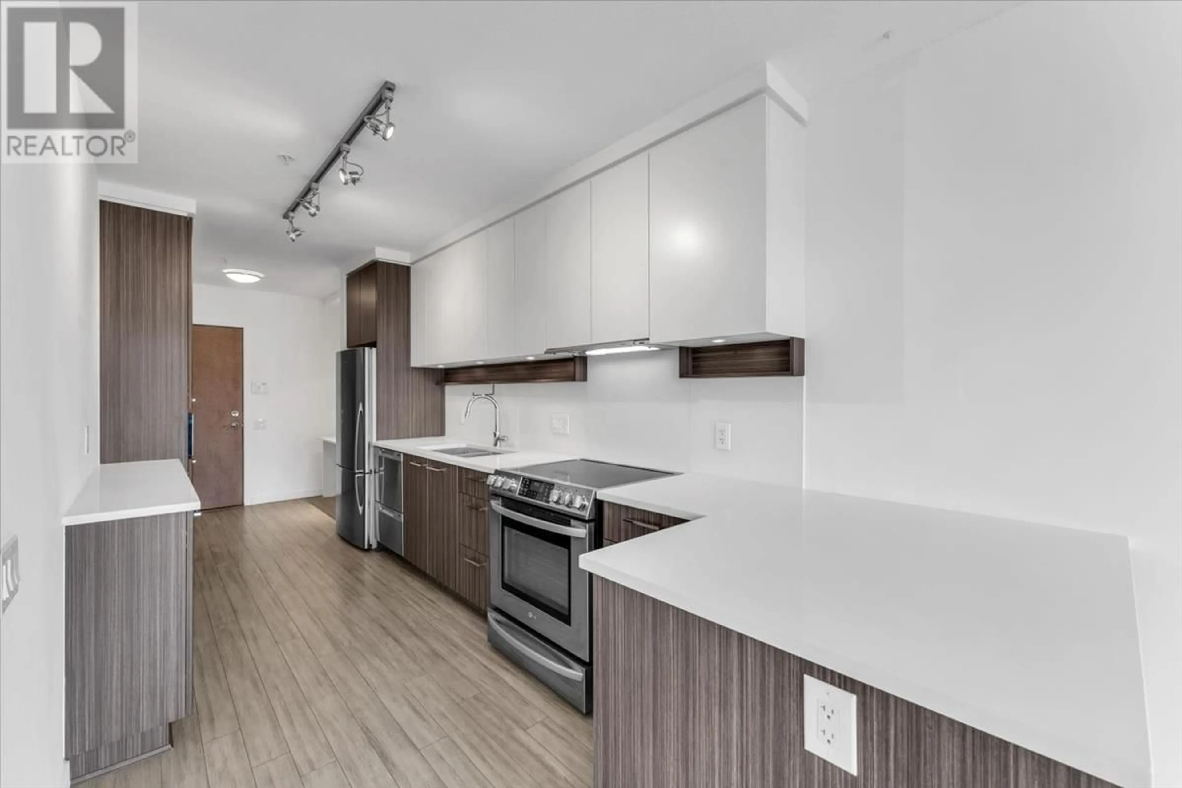 Open concept kitchen, wood/laminate floor for 410 - 4310 HASTINGS STREET, Burnaby British Columbia V5C2J9