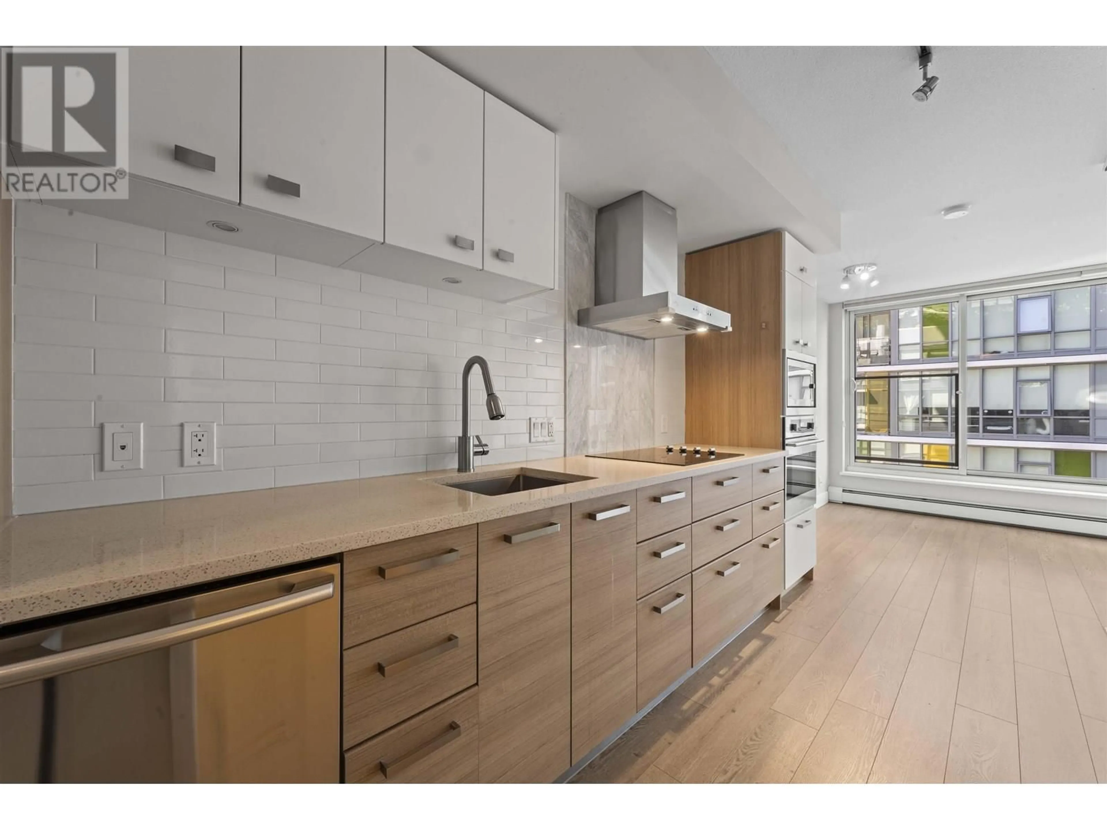 Open concept kitchen, wood/laminate floor for 516 - 1783 MANITOBA STREET, Vancouver British Columbia V5Y0K1