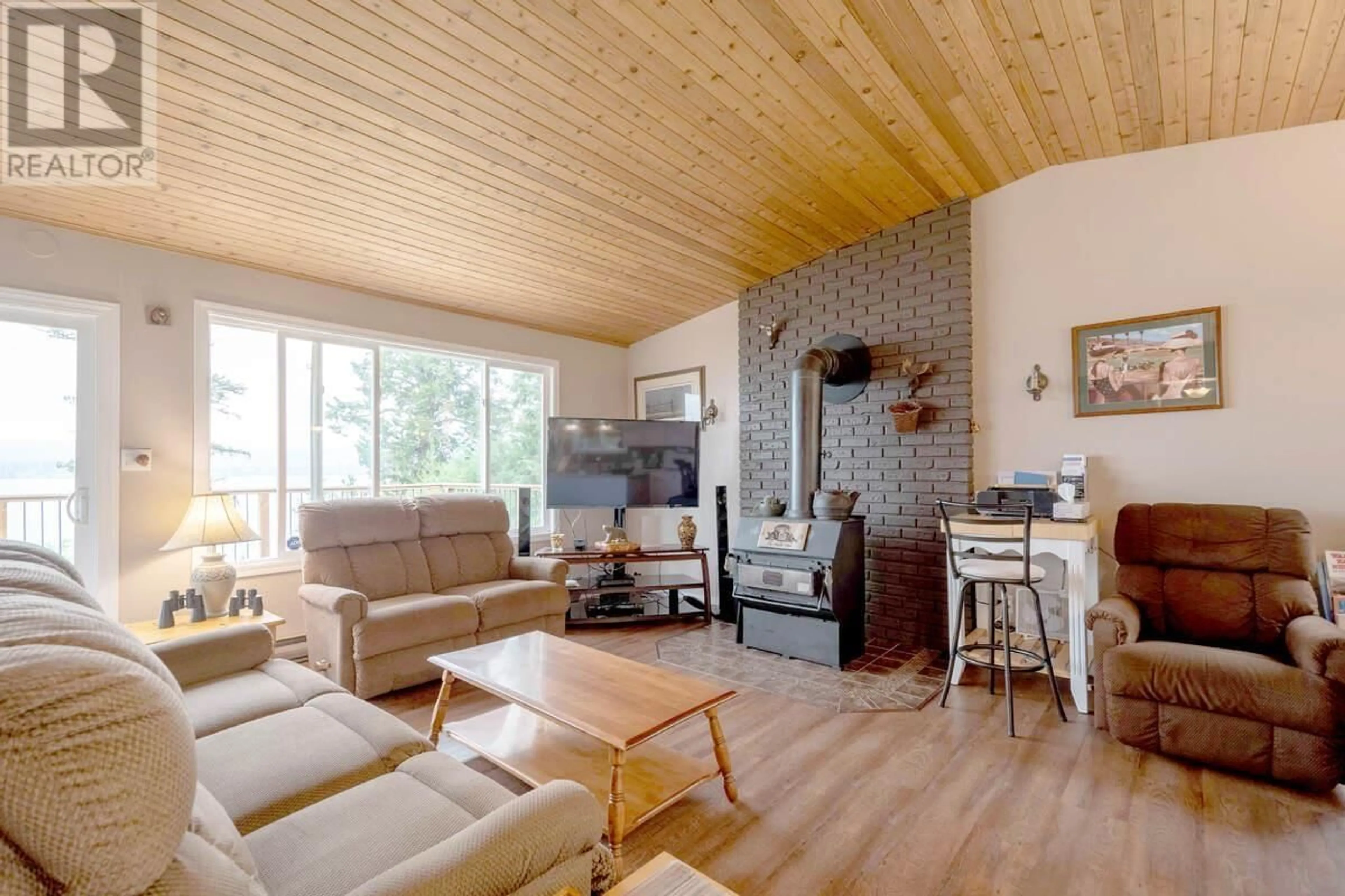 Living room with furniture, wood/laminate floor for 4803 LAKEVIEW ROAD, Lac La Hache British Columbia V0K1T0