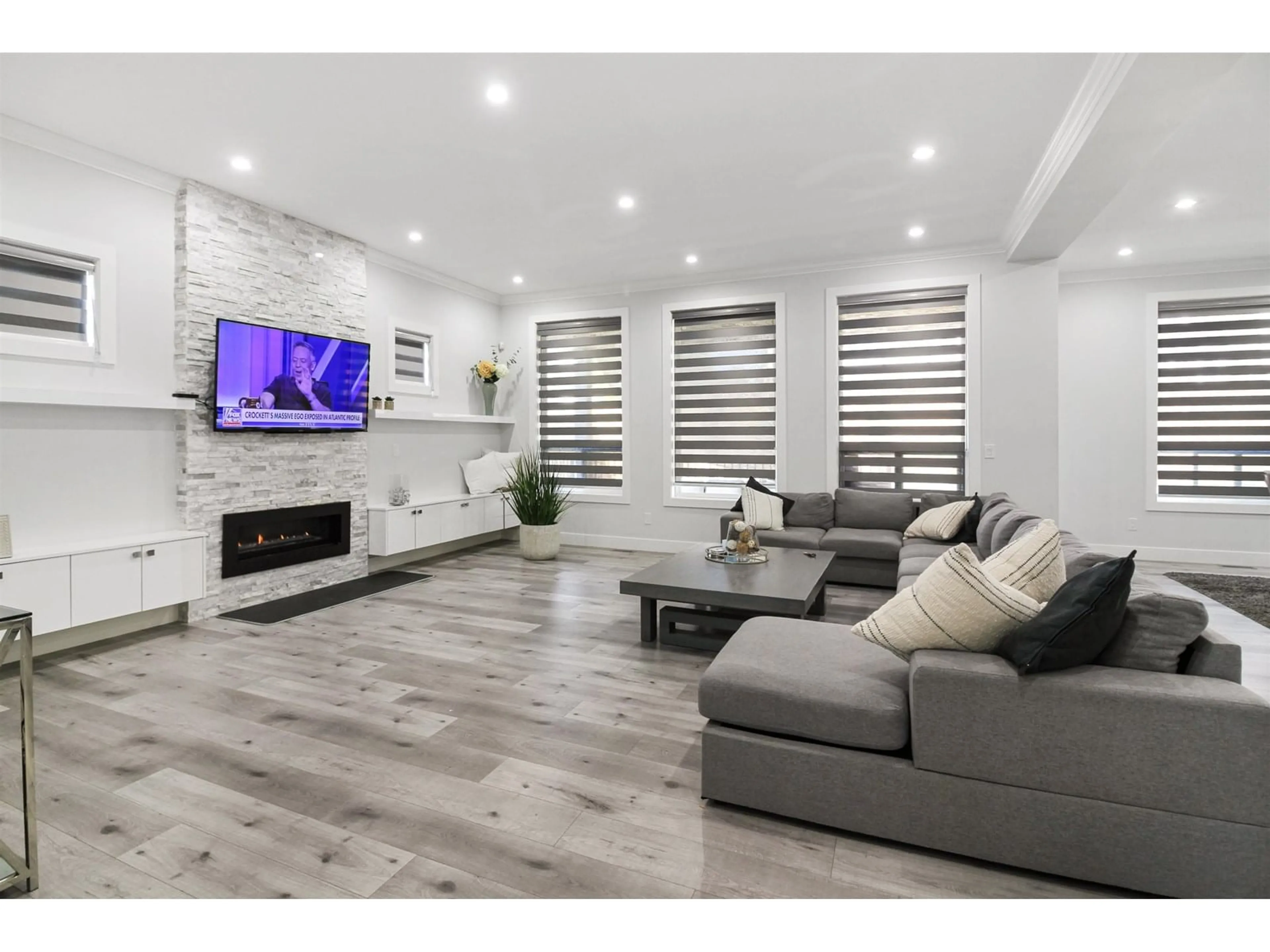 Living room with furniture, wood/laminate floor for 16707 16A, Surrey British Columbia V3Z0B4