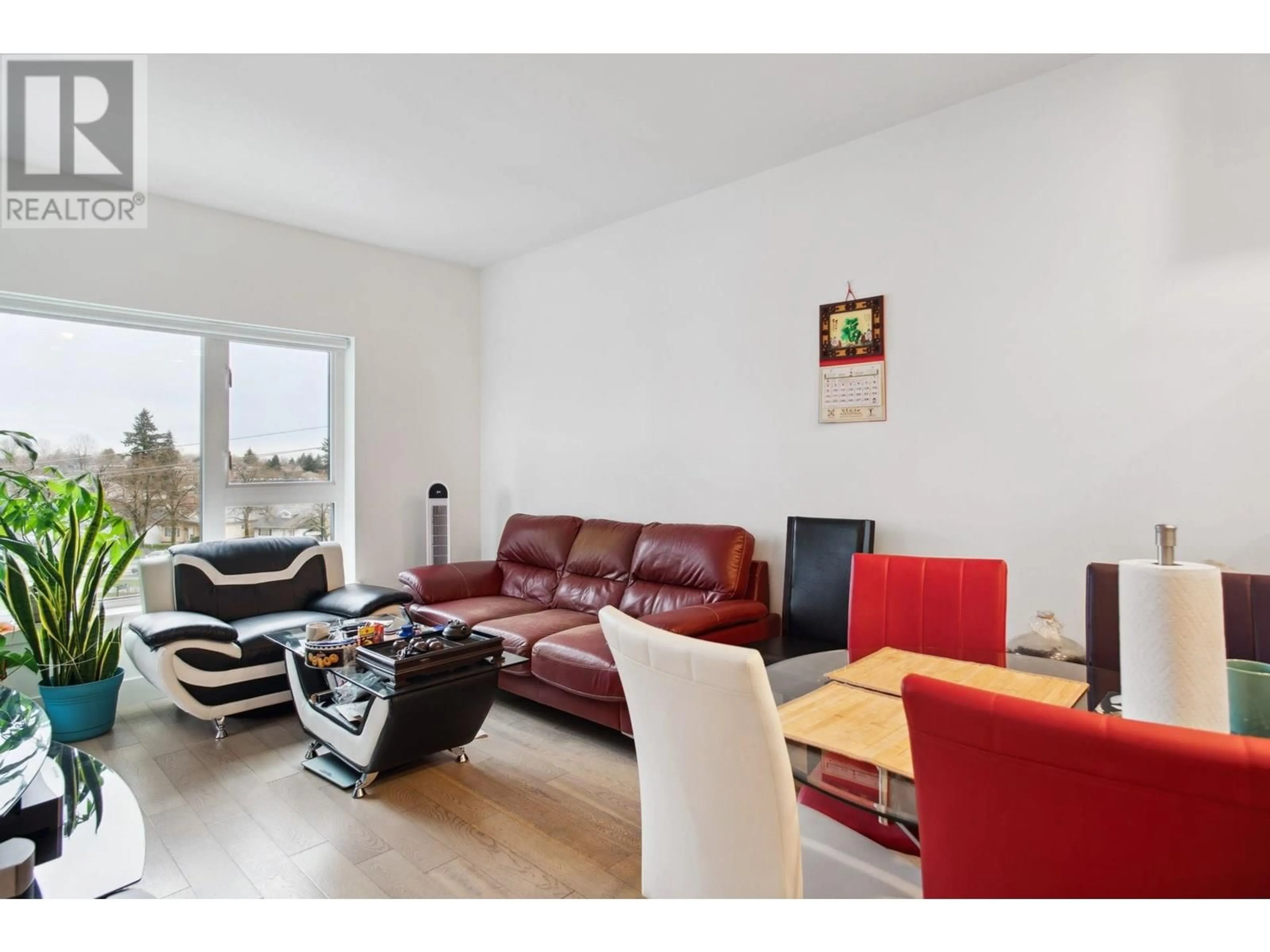 Living room with furniture, wood/laminate floor for 407 - 2666 DUKE STREET, Vancouver British Columbia V5R4S9
