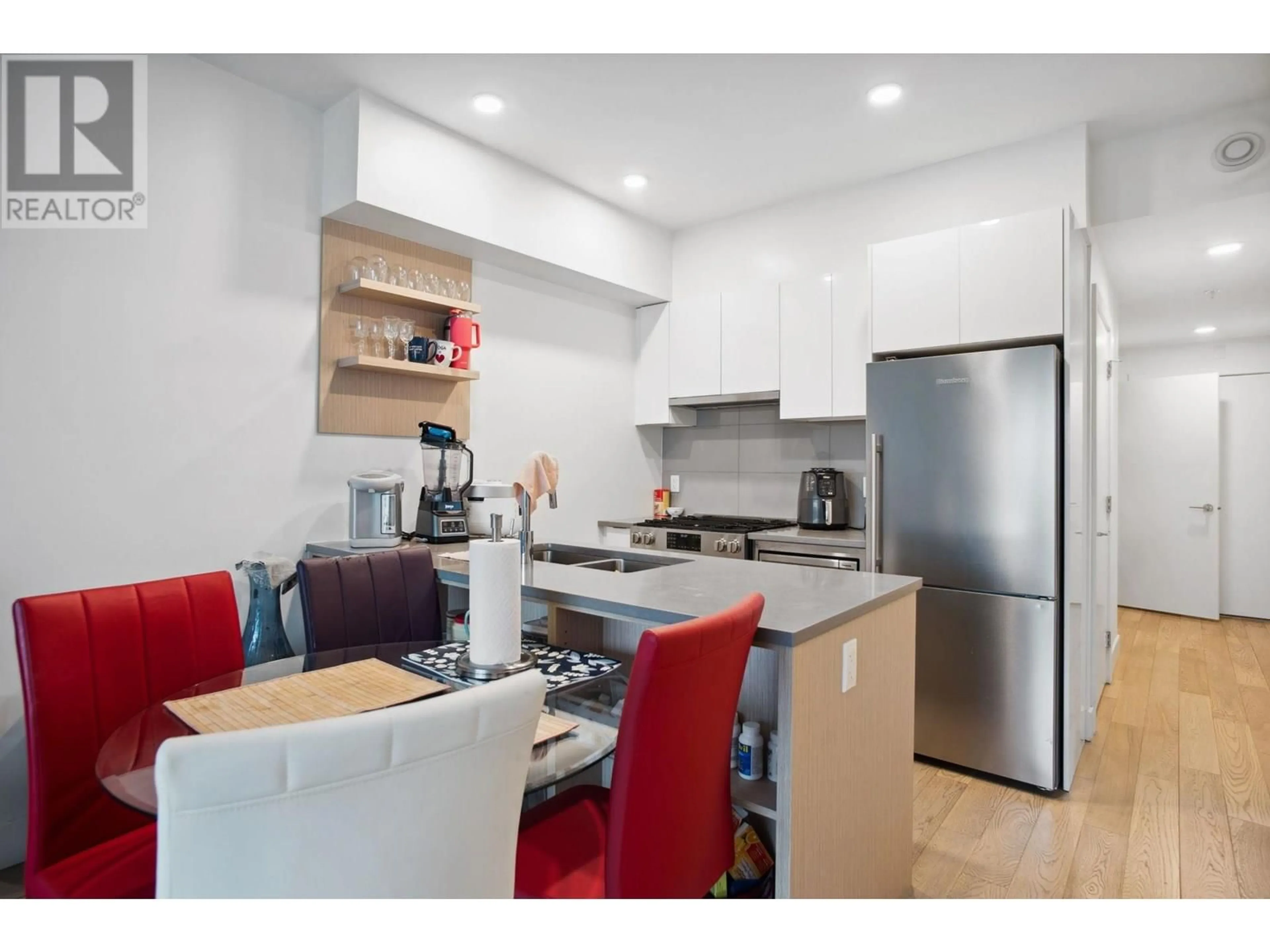 Open concept kitchen, wood/laminate floor for 407 - 2666 DUKE STREET, Vancouver British Columbia V5R4S9