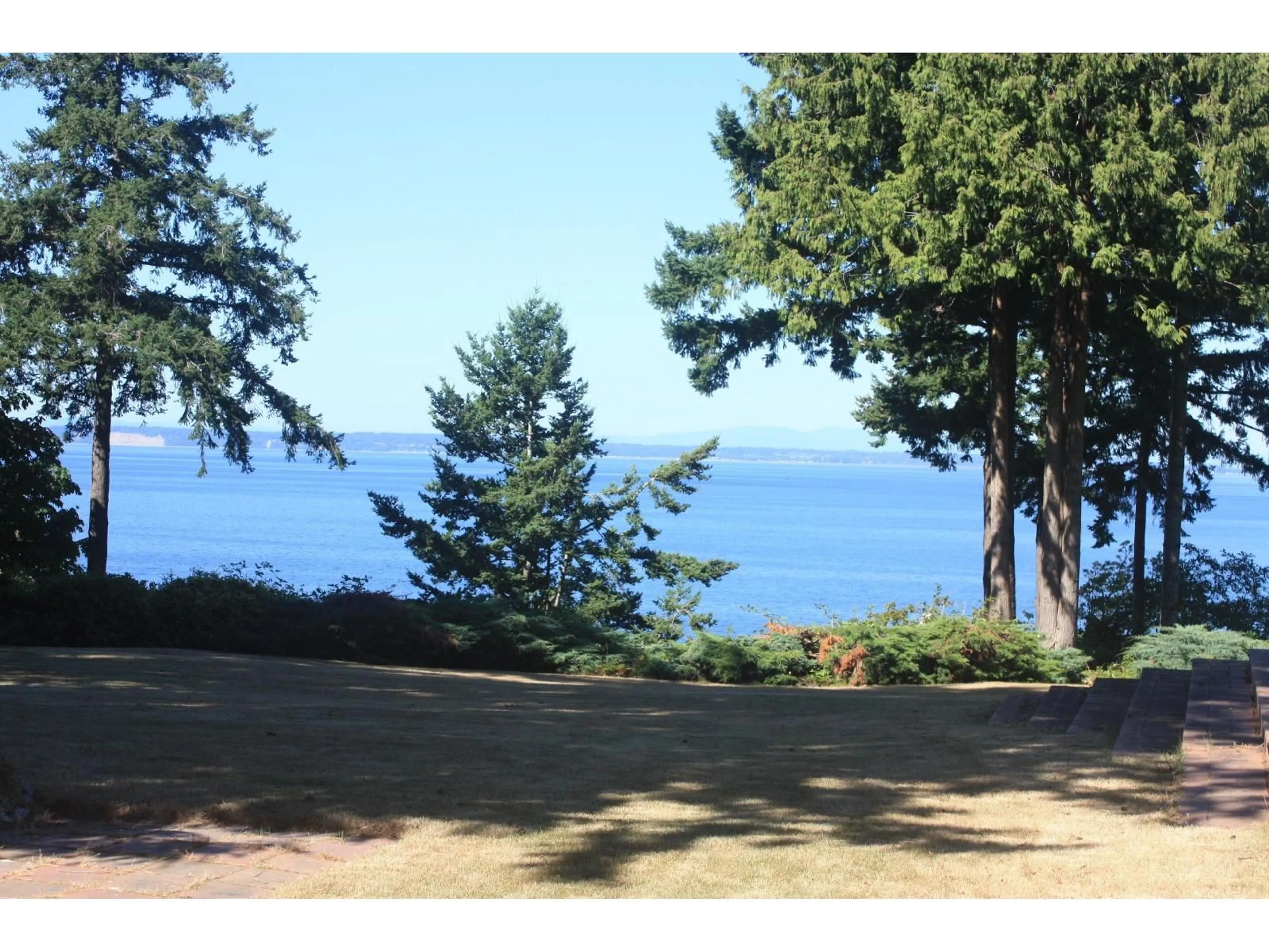 A pic from outside/outdoor area/front of a property/back of a property/a pic from drone, water/lake/river/ocean view for 12581 16, Surrey British Columbia V4A1M7