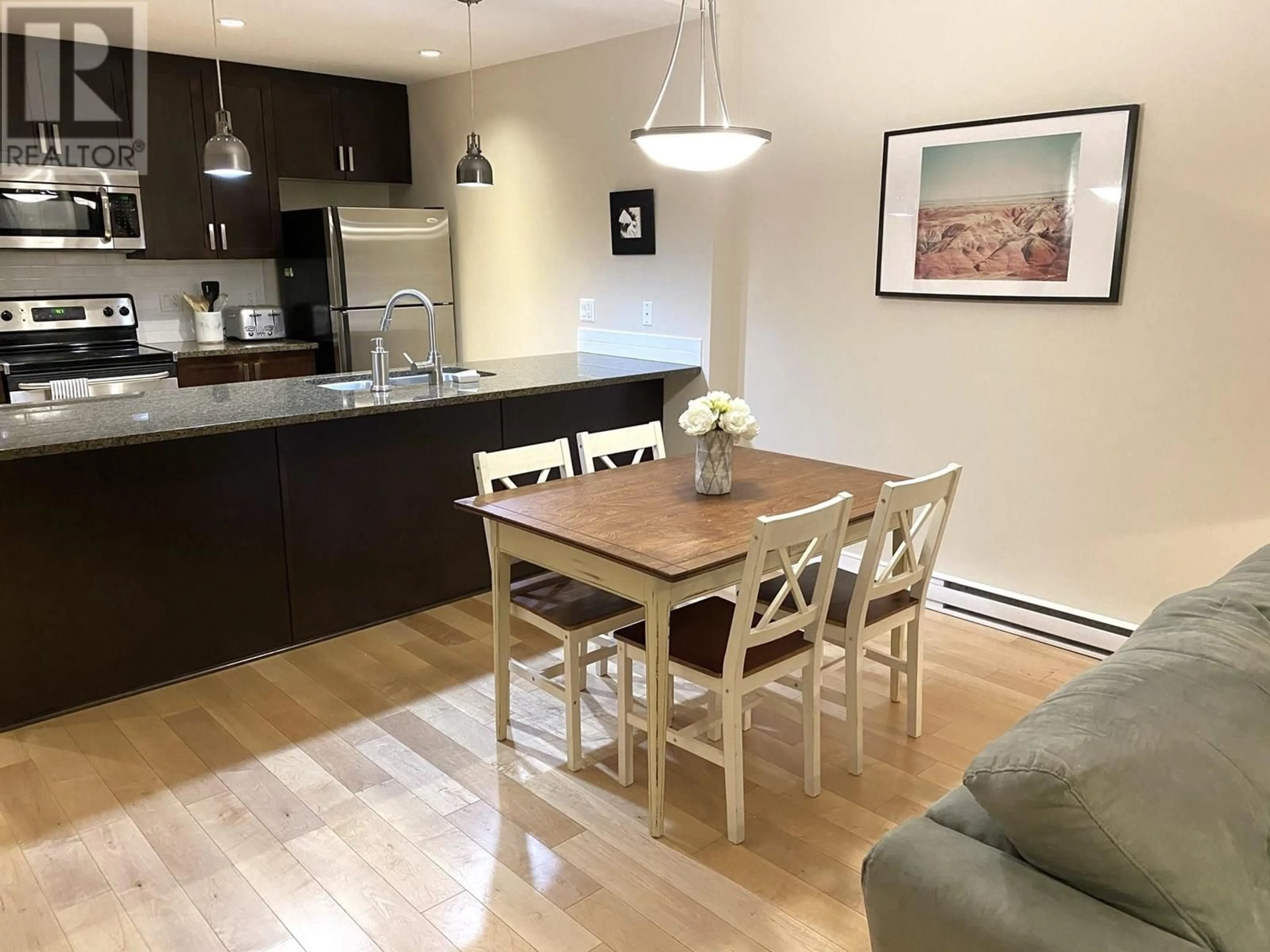 Open concept kitchen, wood/laminate floor for 405 - 5599 14B AVENUE, Delta British Columbia V4M0A3