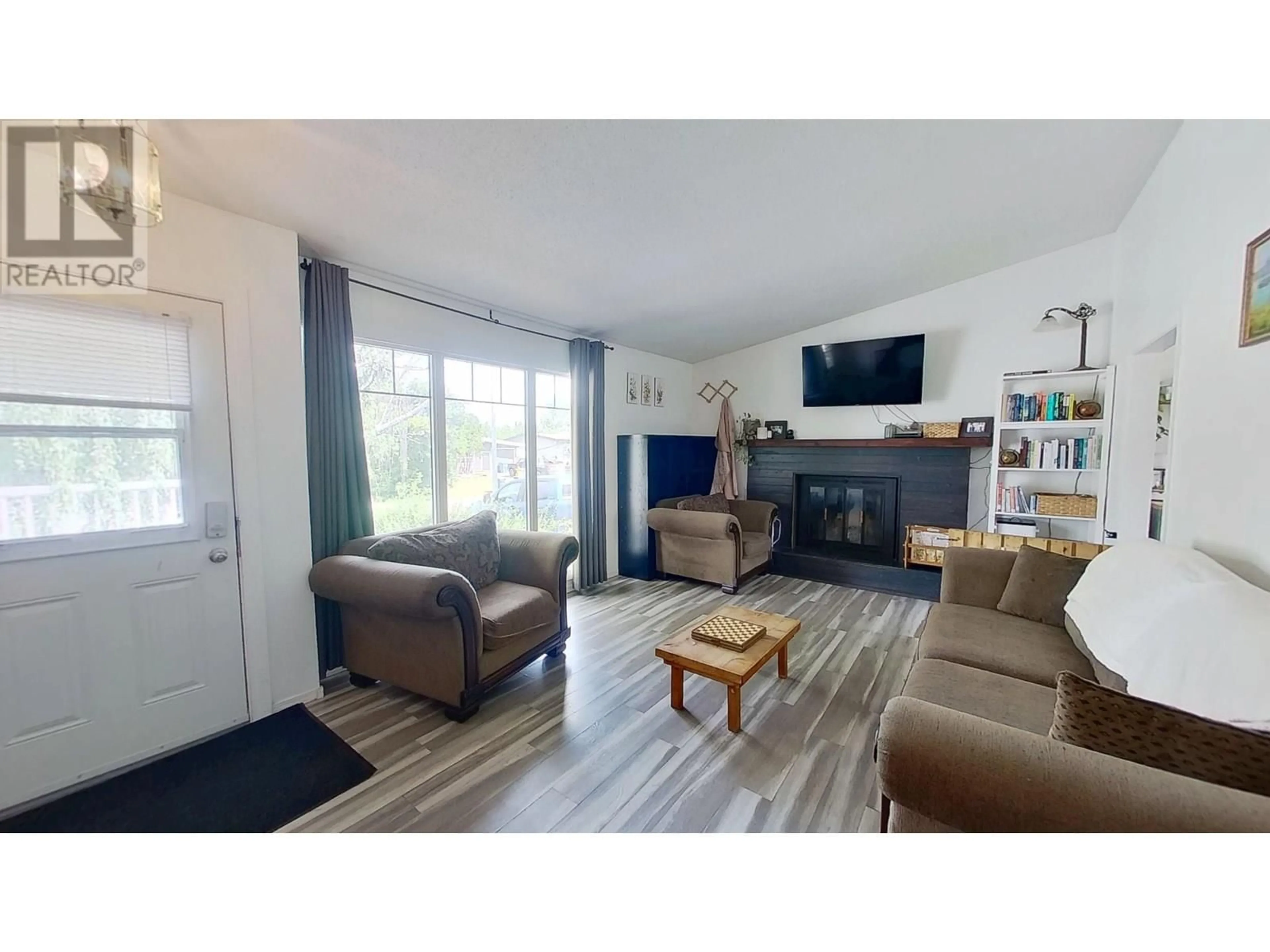Living room with furniture, wood/laminate floor for 9523 113 AVENUE, Fort St. John British Columbia V1J2X1