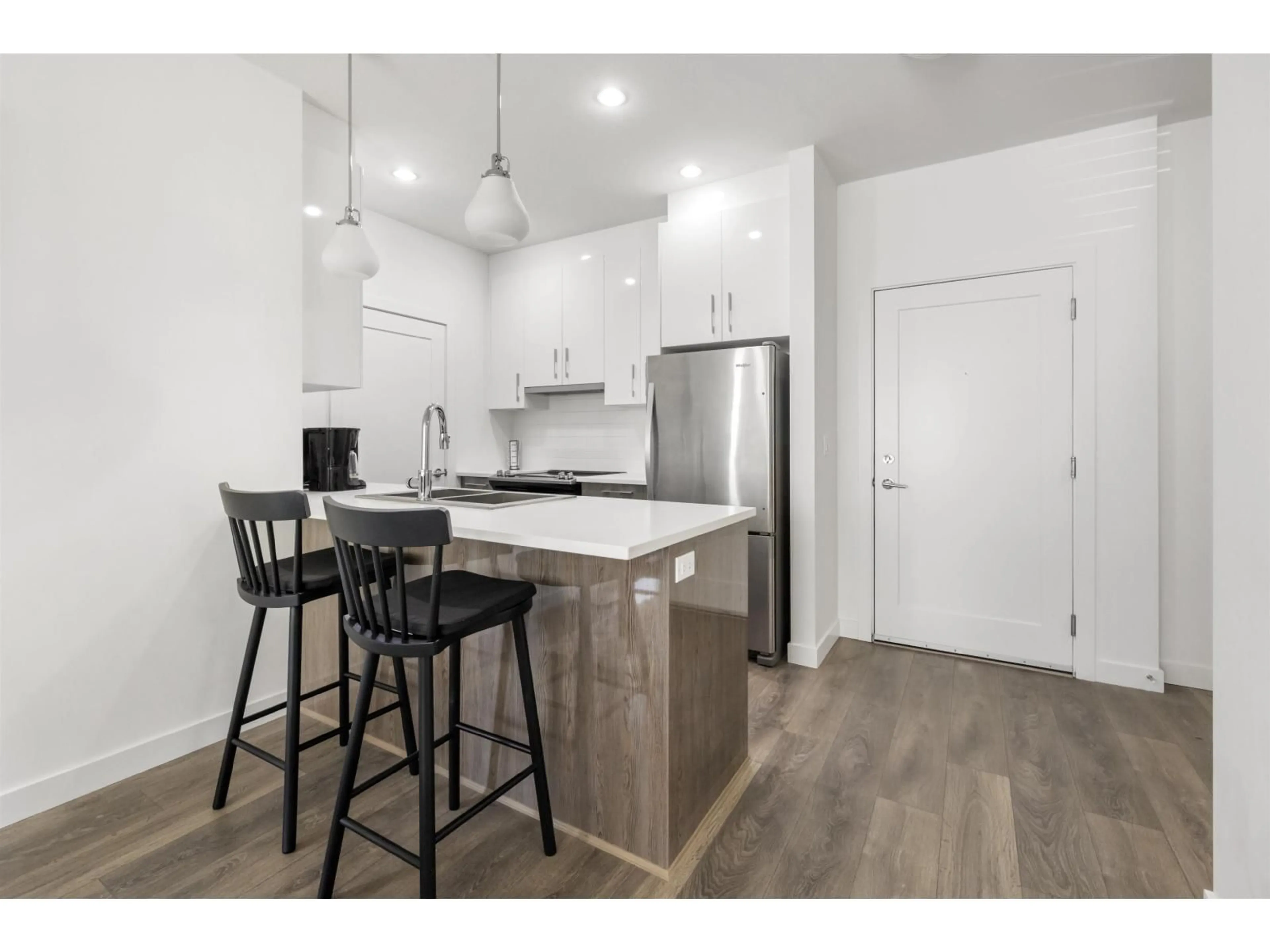 Open concept kitchen, wood/laminate floor for 210 - 20829 77A, Langley British Columbia V2Y0W7