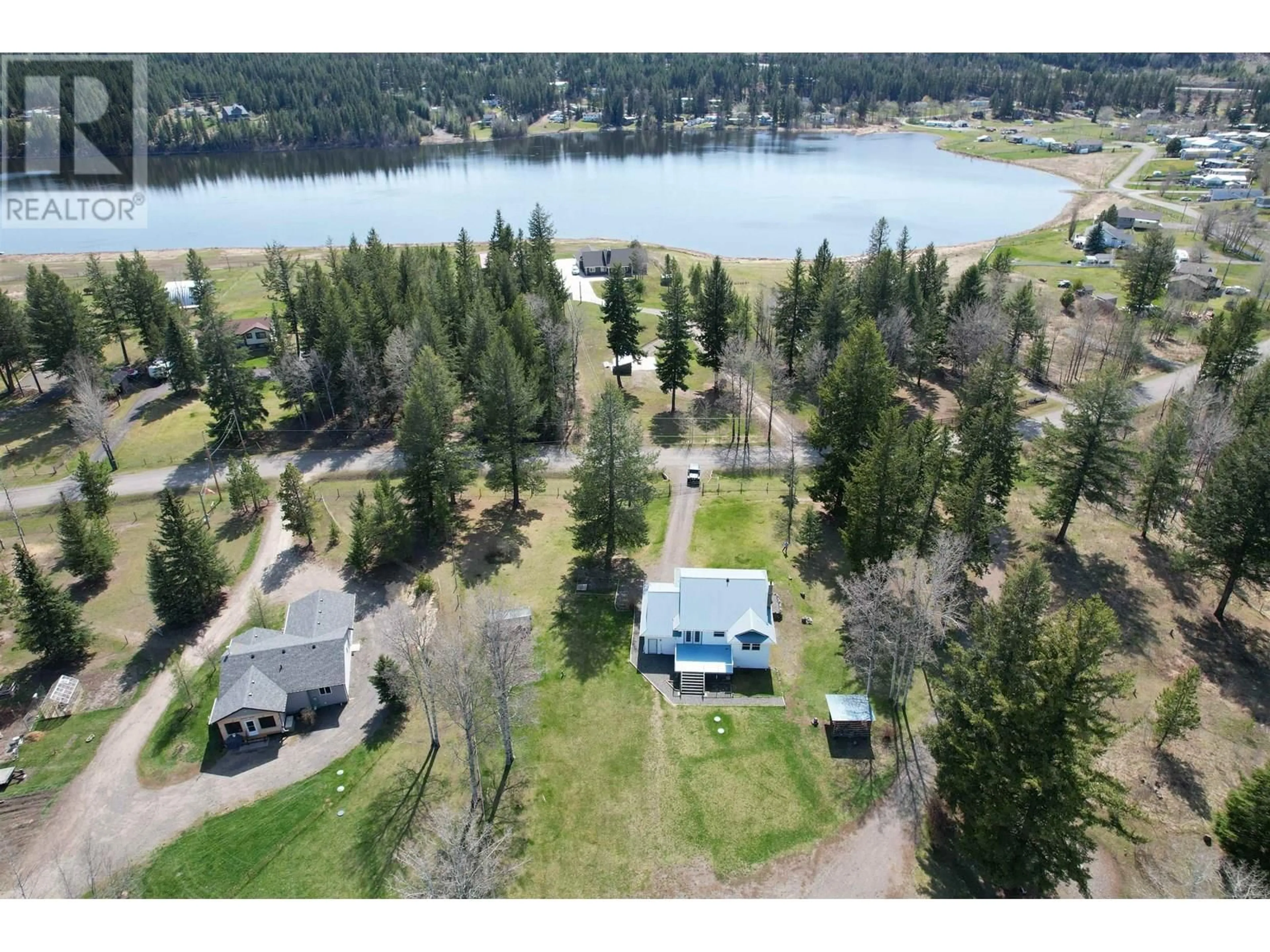 A pic from outside/outdoor area/front of a property/back of a property/a pic from drone, water/lake/river/ocean view for 5571 LAKESIDE COURT, 103 Mile House British Columbia V0K2E1