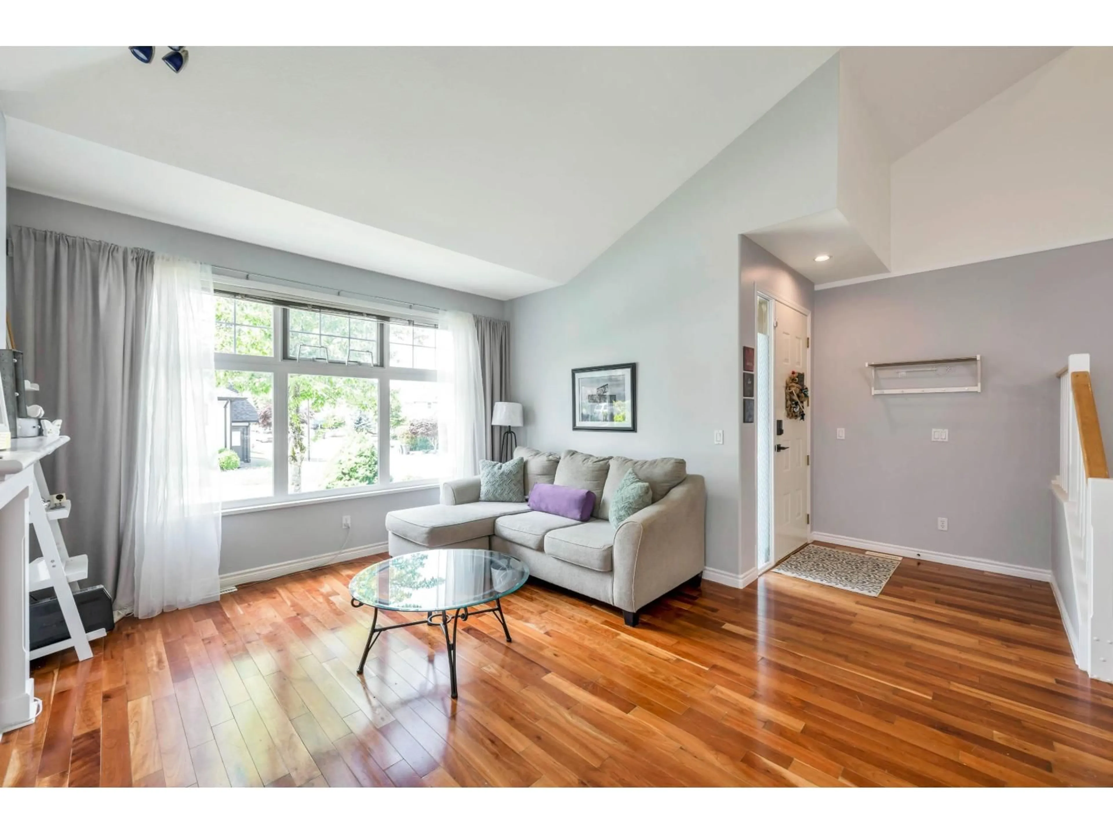 Living room with furniture, wood/laminate floor for 7536 147A, Surrey British Columbia V3S8Y6