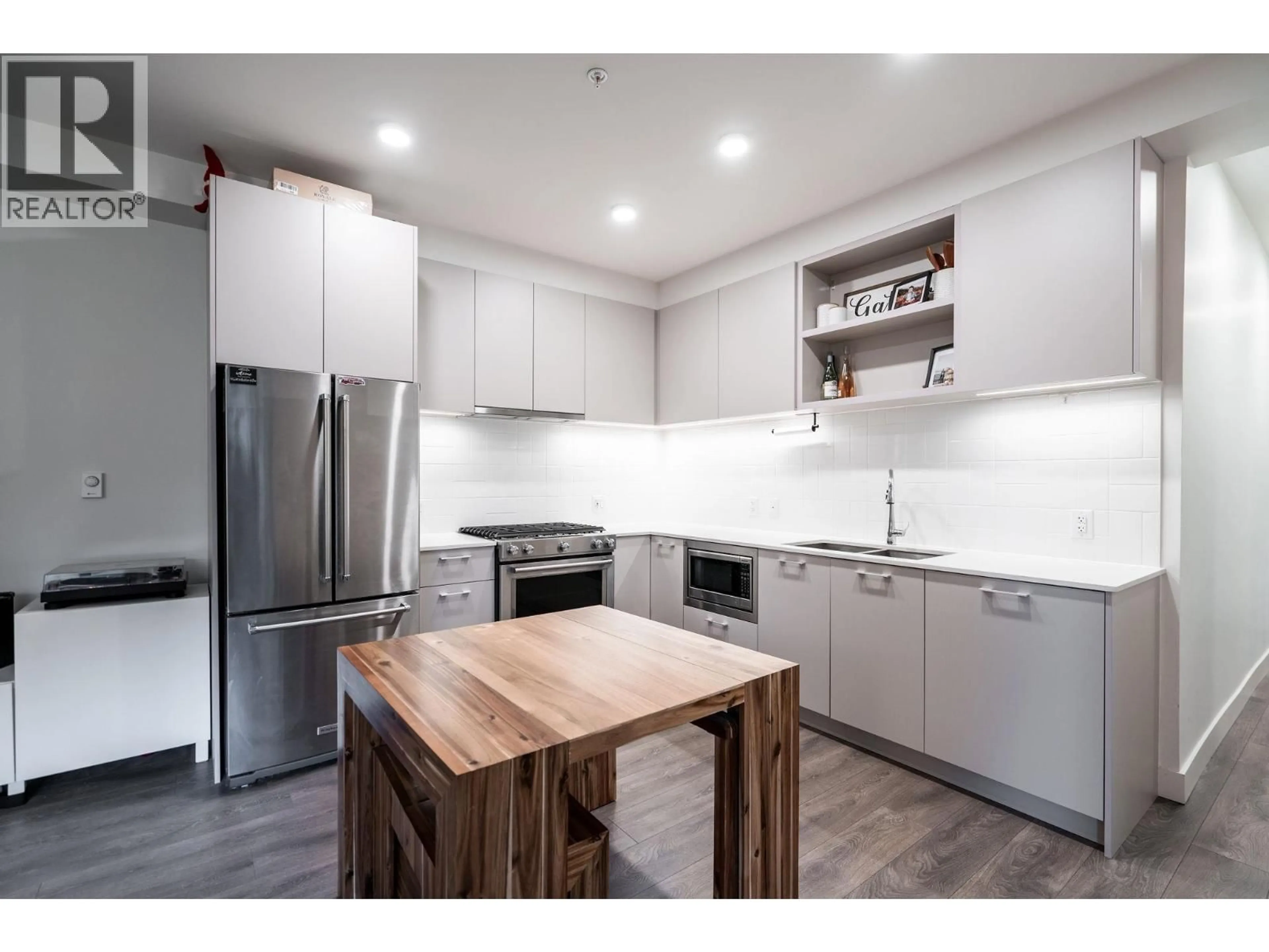 Open concept kitchen, wood/laminate floor for 101 - 741 ANSKAR COURT, Coquitlam British Columbia V3J0N3
