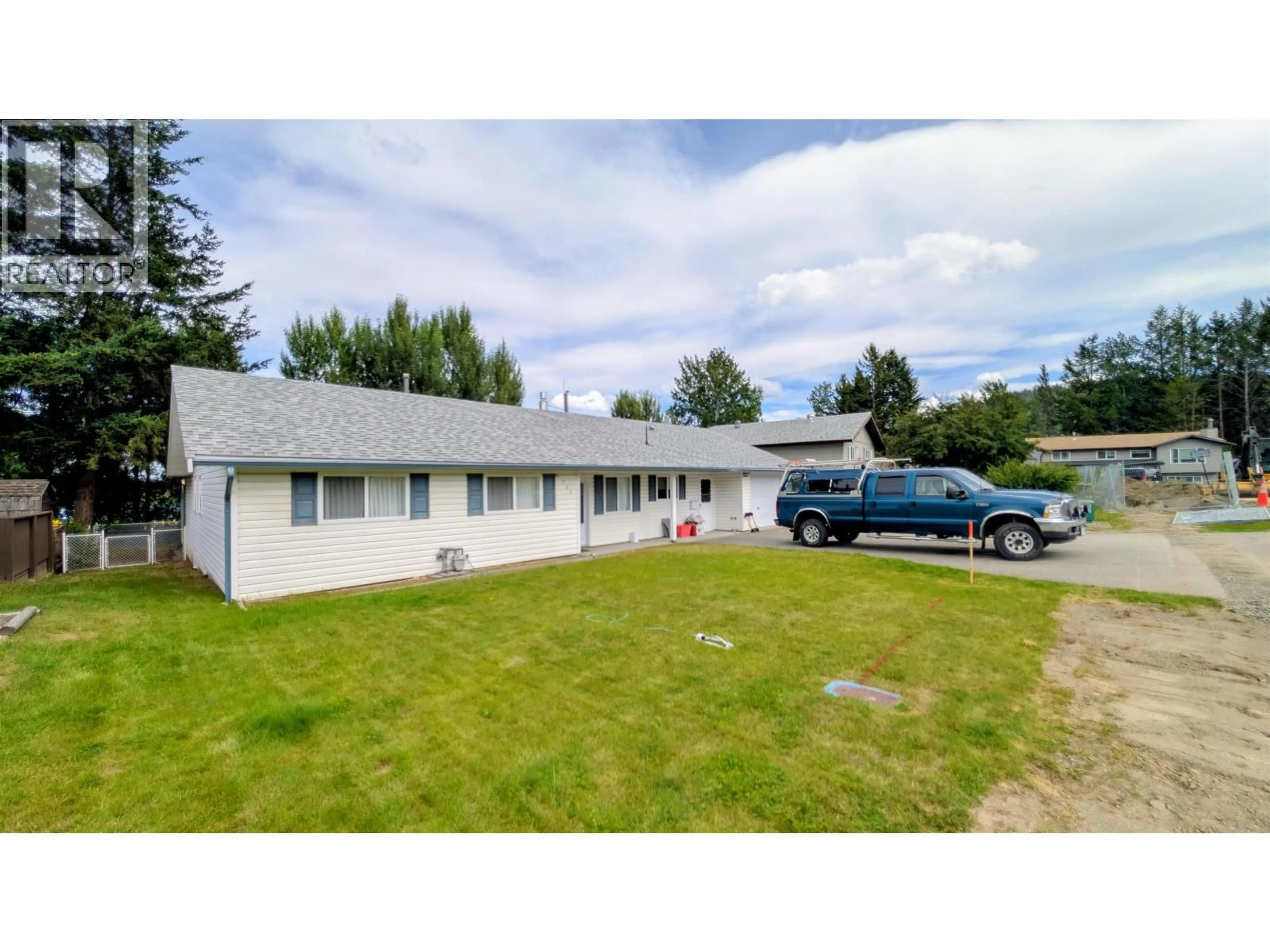 A pic from outside/outdoor area/front of a property/back of a property/a pic from drone, unknown for 703 BURGHLEY PLACE, 100 Mile House British Columbia V0K2E0