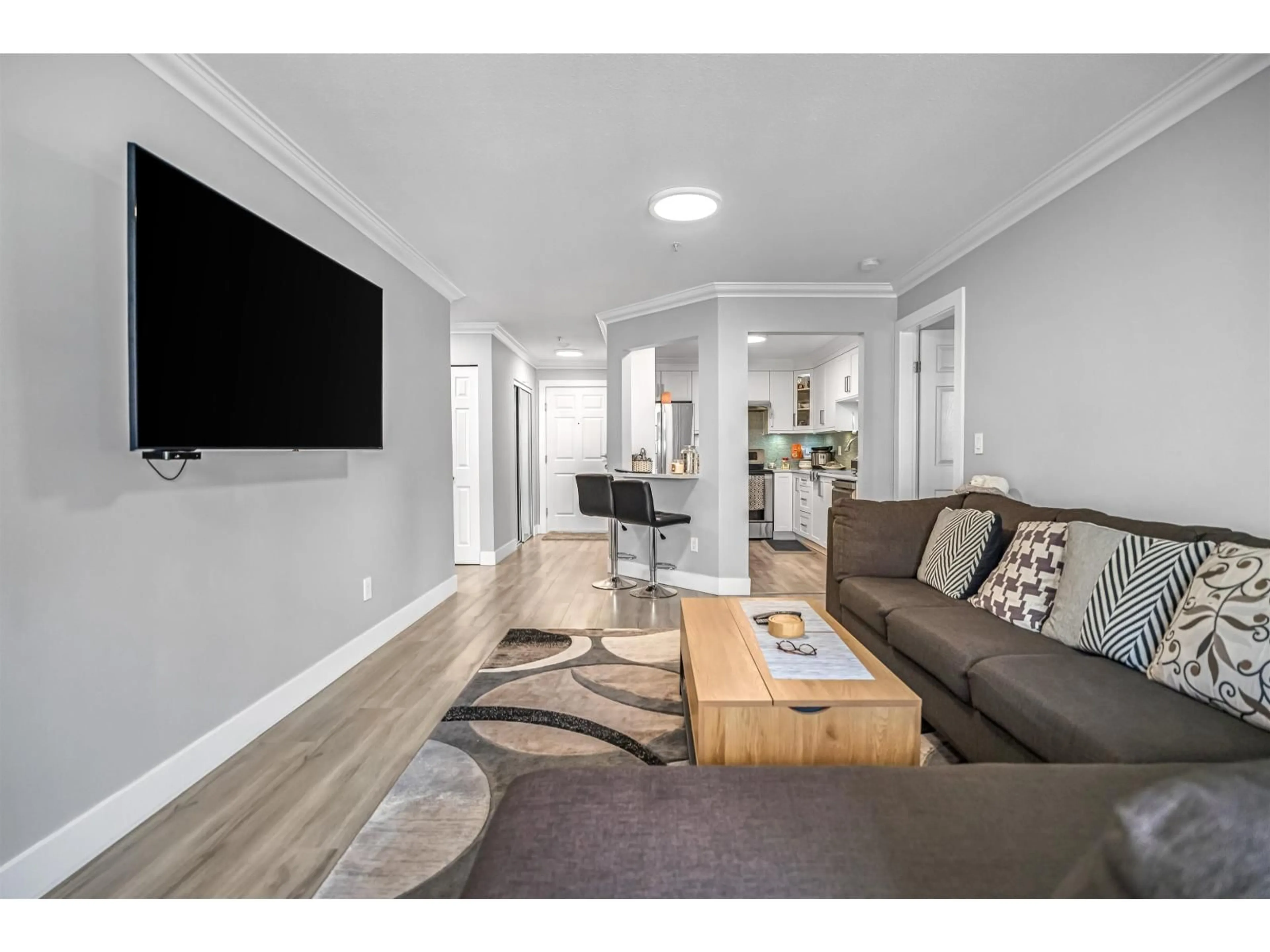 Living room with furniture, wood/laminate floor for #205 - 8068 120A, Surrey British Columbia V3W3P3