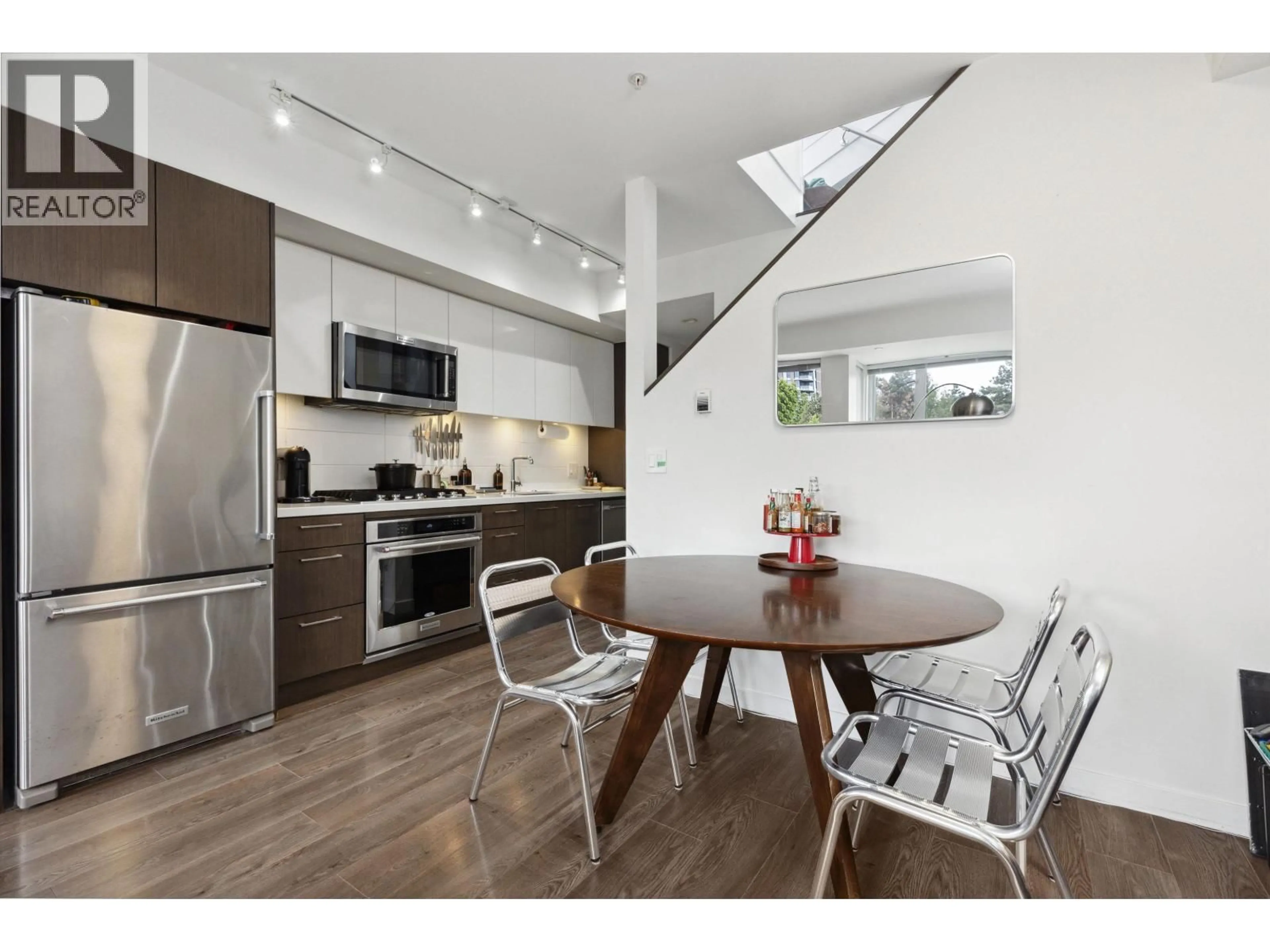 Open concept kitchen, wood/laminate floor for 605 - 417 GREAT NORTHERN WAY, Vancouver British Columbia V5T0G7