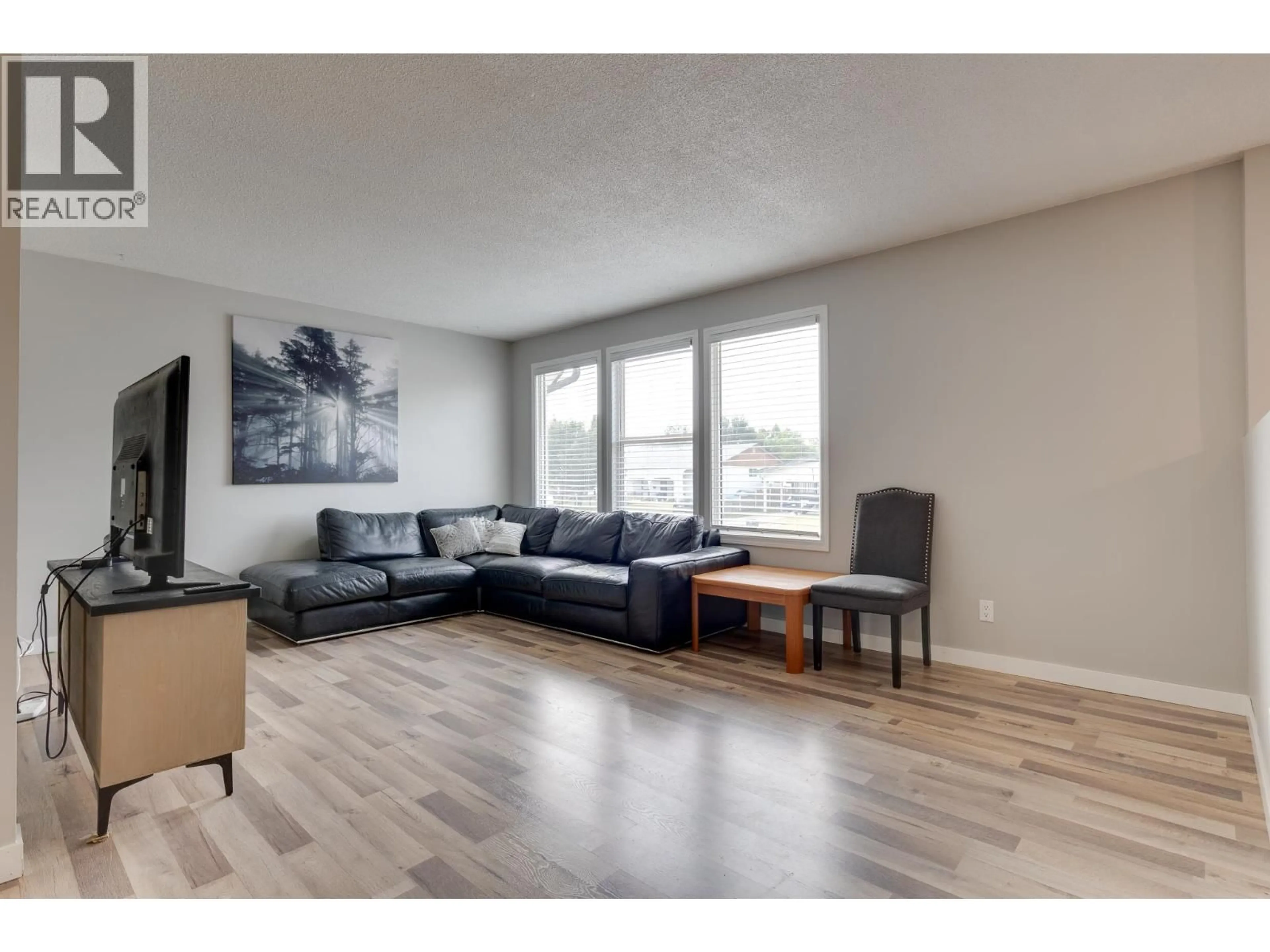 Living room with furniture, wood/laminate floor for 4258 QUENTIN AVENUE, Prince George British Columbia V2M5L3