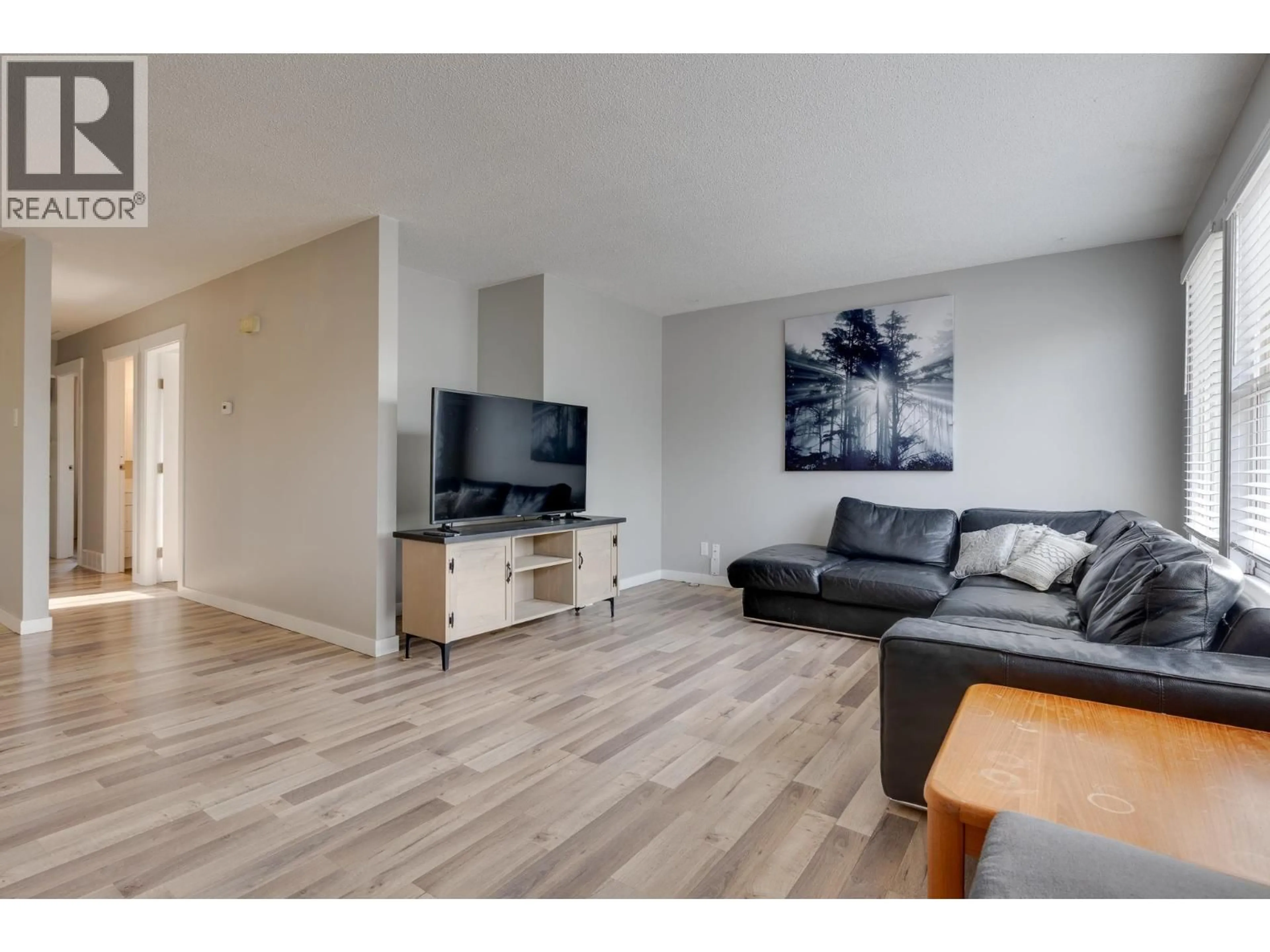 Living room with furniture, wood/laminate floor for 4258 QUENTIN AVENUE, Prince George British Columbia V2M5L3