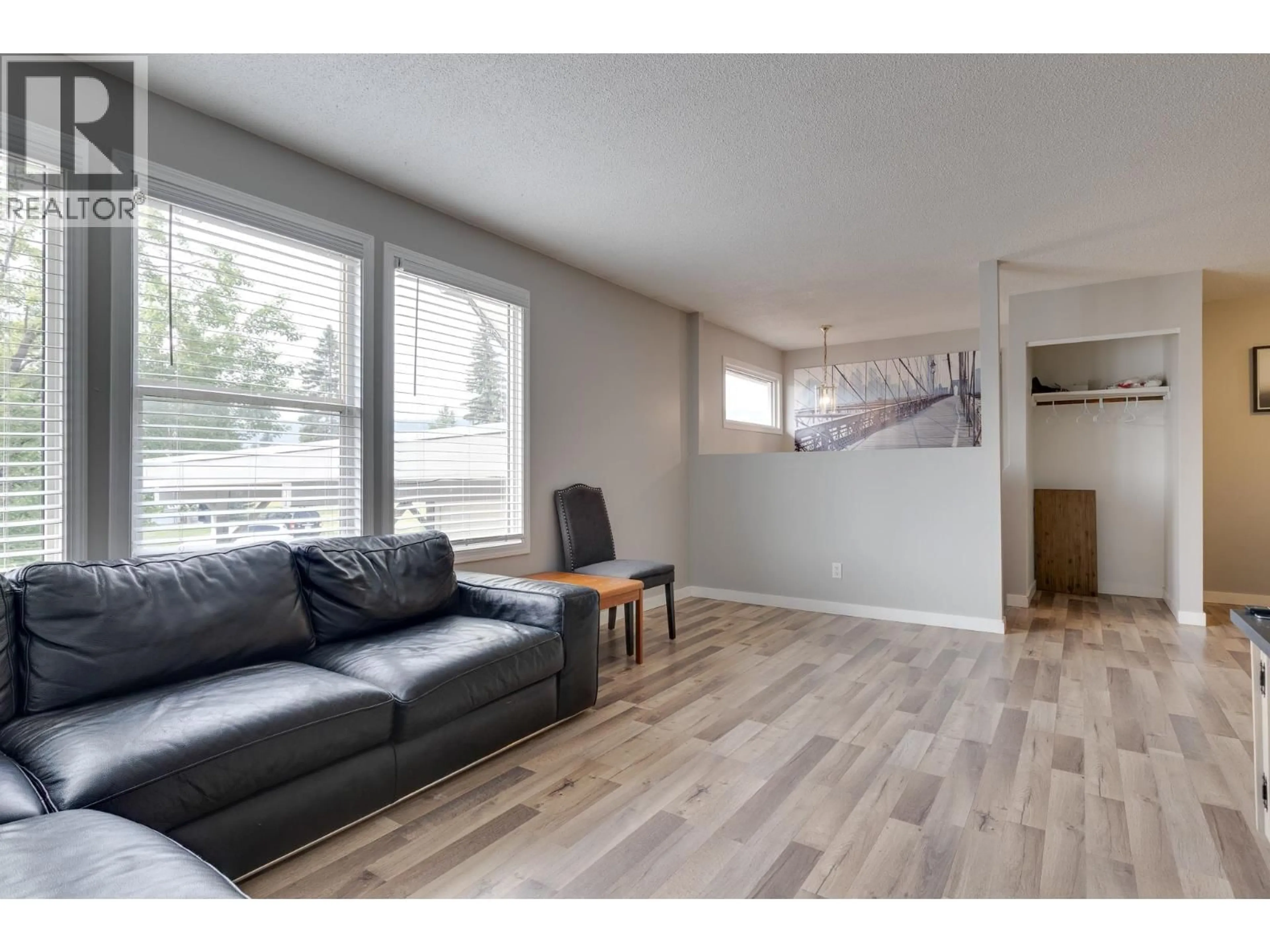 Living room with furniture, wood/laminate floor for 4258 QUENTIN AVENUE, Prince George British Columbia V2M5L3
