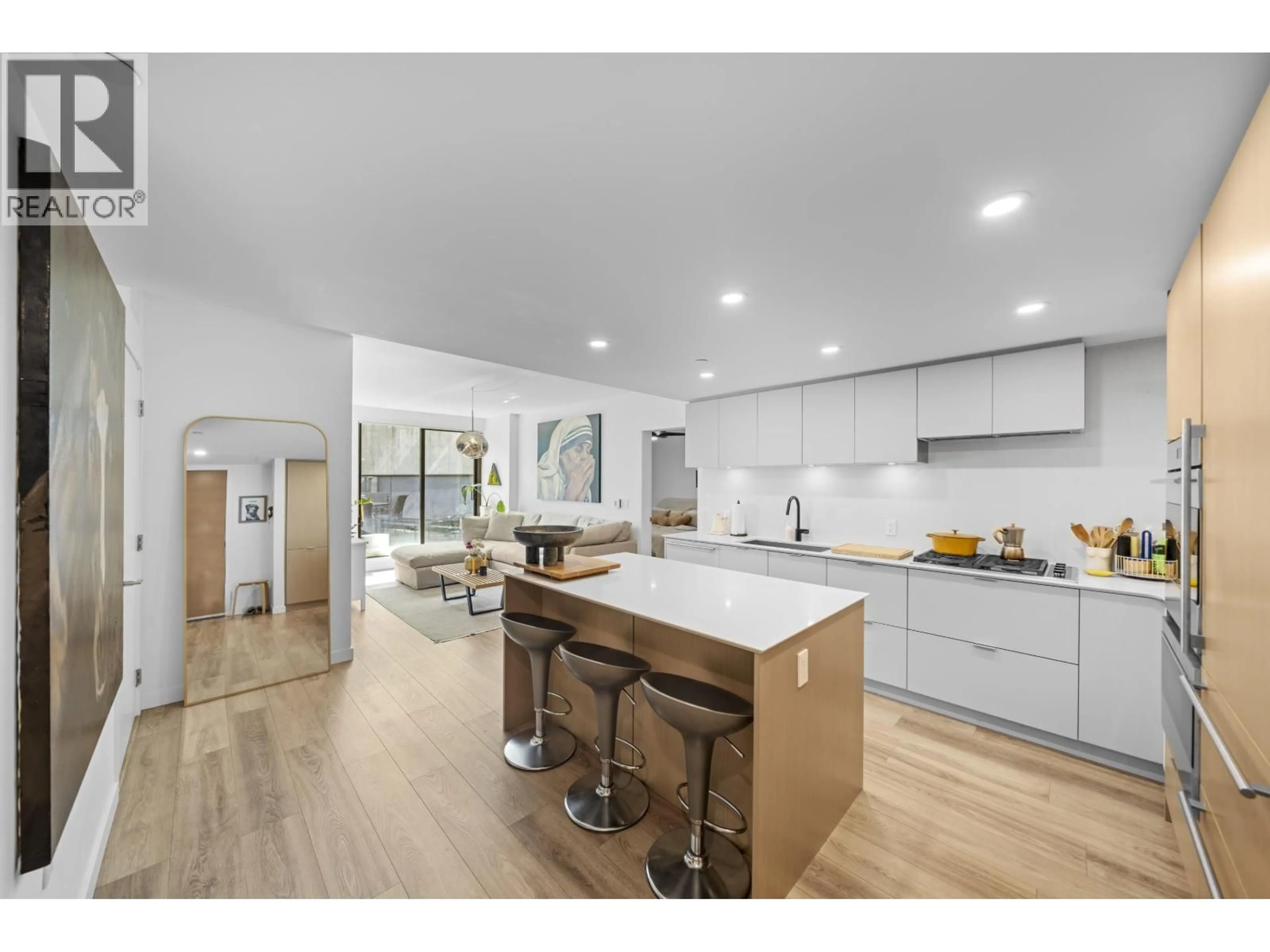 Open concept kitchen, wood/laminate floor for 302 - 210 5TH AVENUE, Vancouver British Columbia V5T0K1